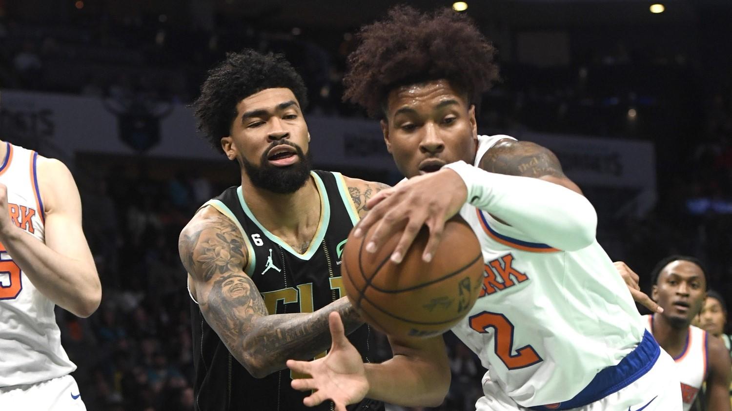 Dec 9, 2022; Charlotte, North Carolina, USA; New York Knicks guard Miles McBride (2) and Charlotte Hornets center Nick Richards (4) go after a loose ball during the second half at the Spectrum Center. / Sam Sharpe-USA TODAY Sports