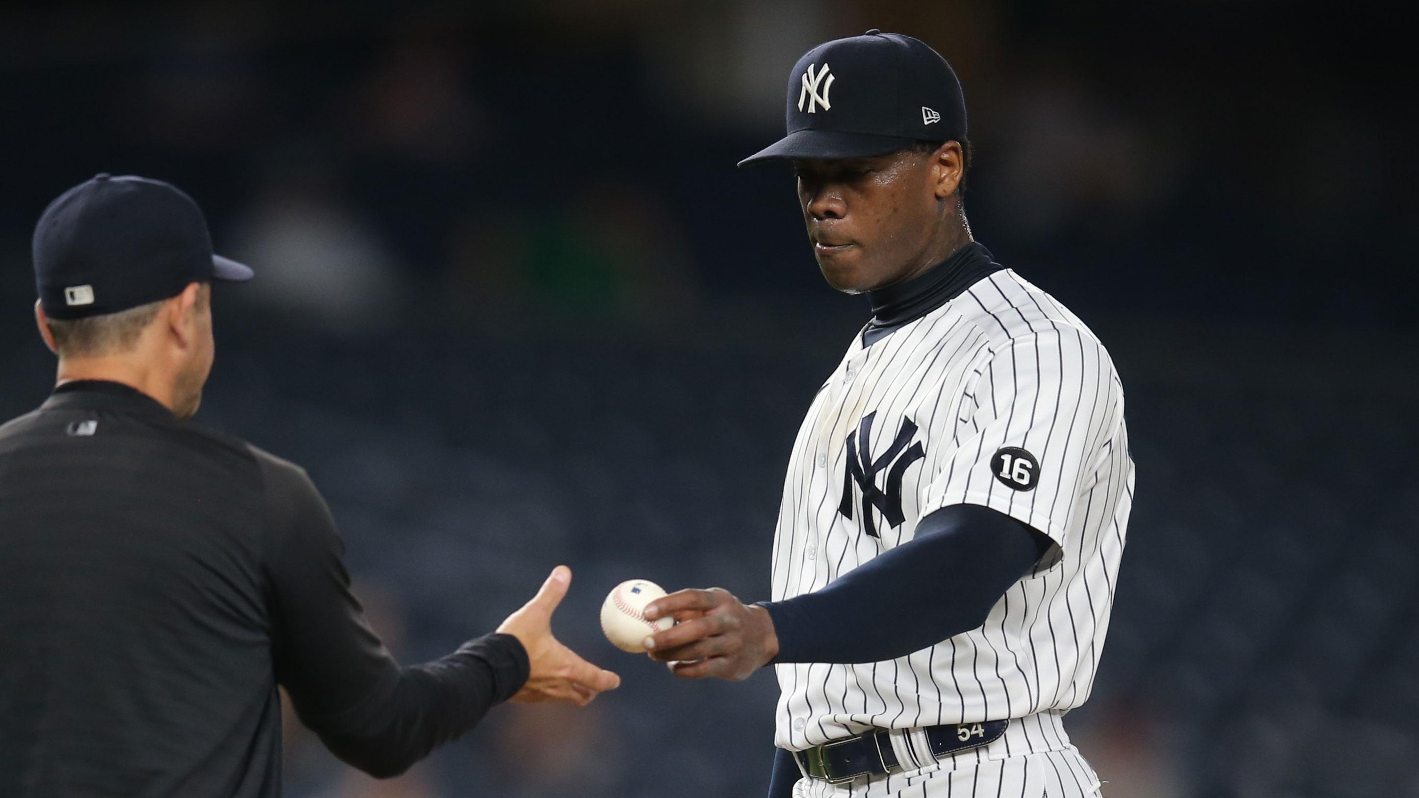 Jun 30, 2021; Bronx, New York, USA; New York Yankees manager Aaron Boone (left) takes relief pitcher Aroldis Chapman (right) out of the game against the Los Angeles Angels during the ninth inning at Yankee Stadium. / Brad Penner-USA TODAY Sports