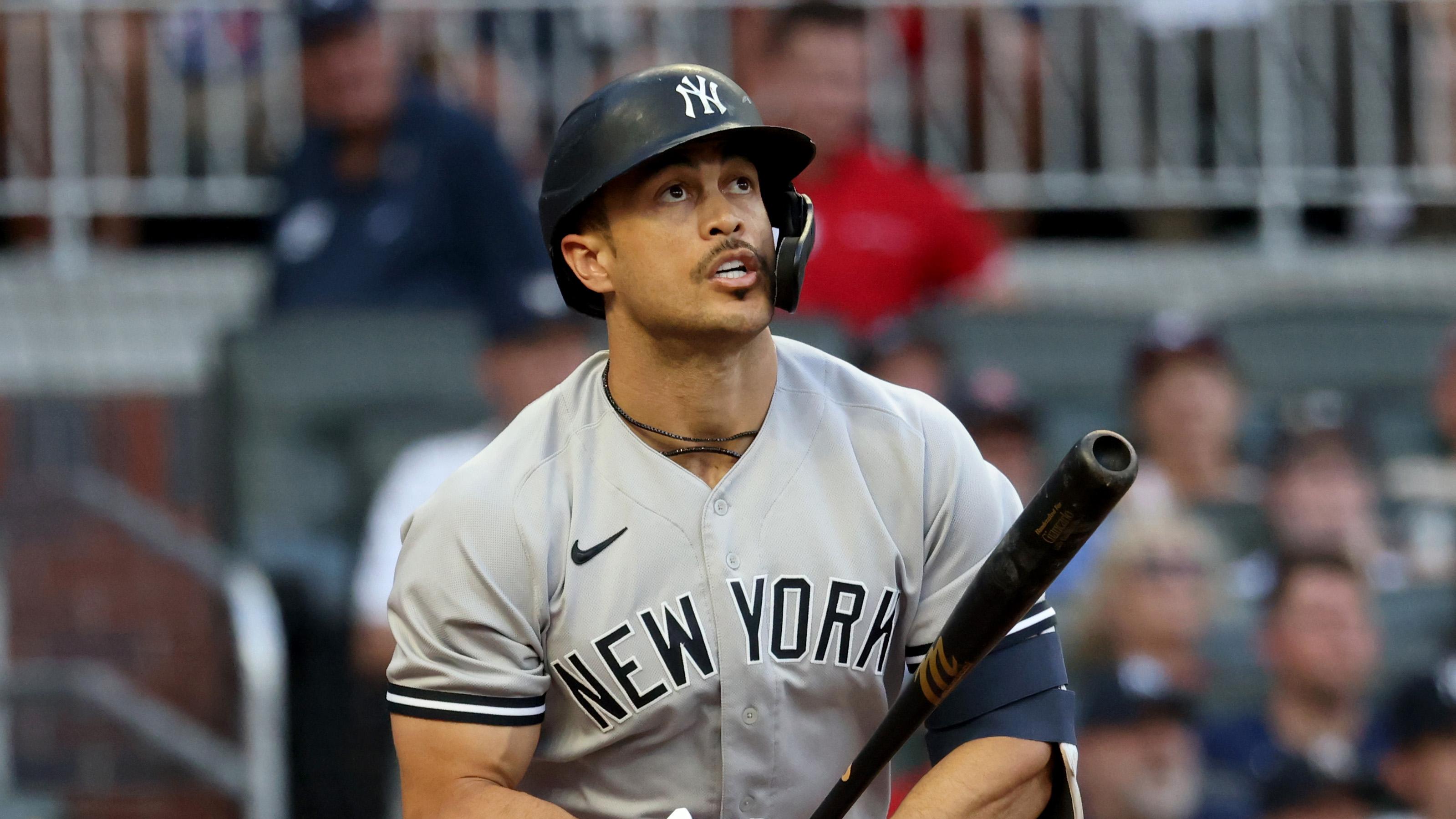 New York Yankees outfielder Giancarlo Stanton (27) hits a solo home run against the Atlanta Braves during the second inning at Truist Park. / Jason Getz - USA TODAY Sports