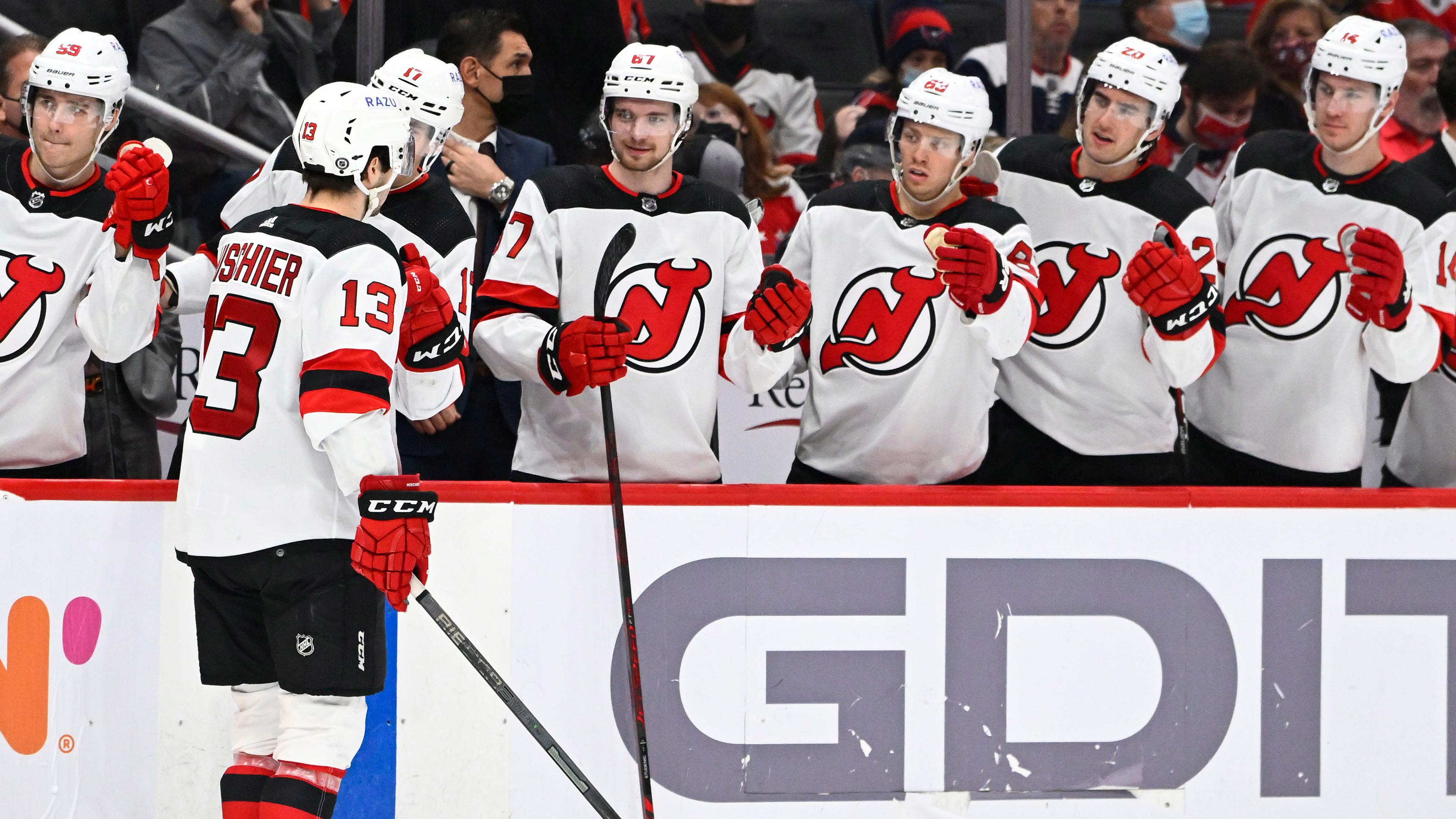 New Jersey Devils center Nico Hischier (13) is congratulated by teammates after scoring a goal against the Washington Capitals during the second period at Capital One Arena. / Brad Mills-USA TODAY Sports