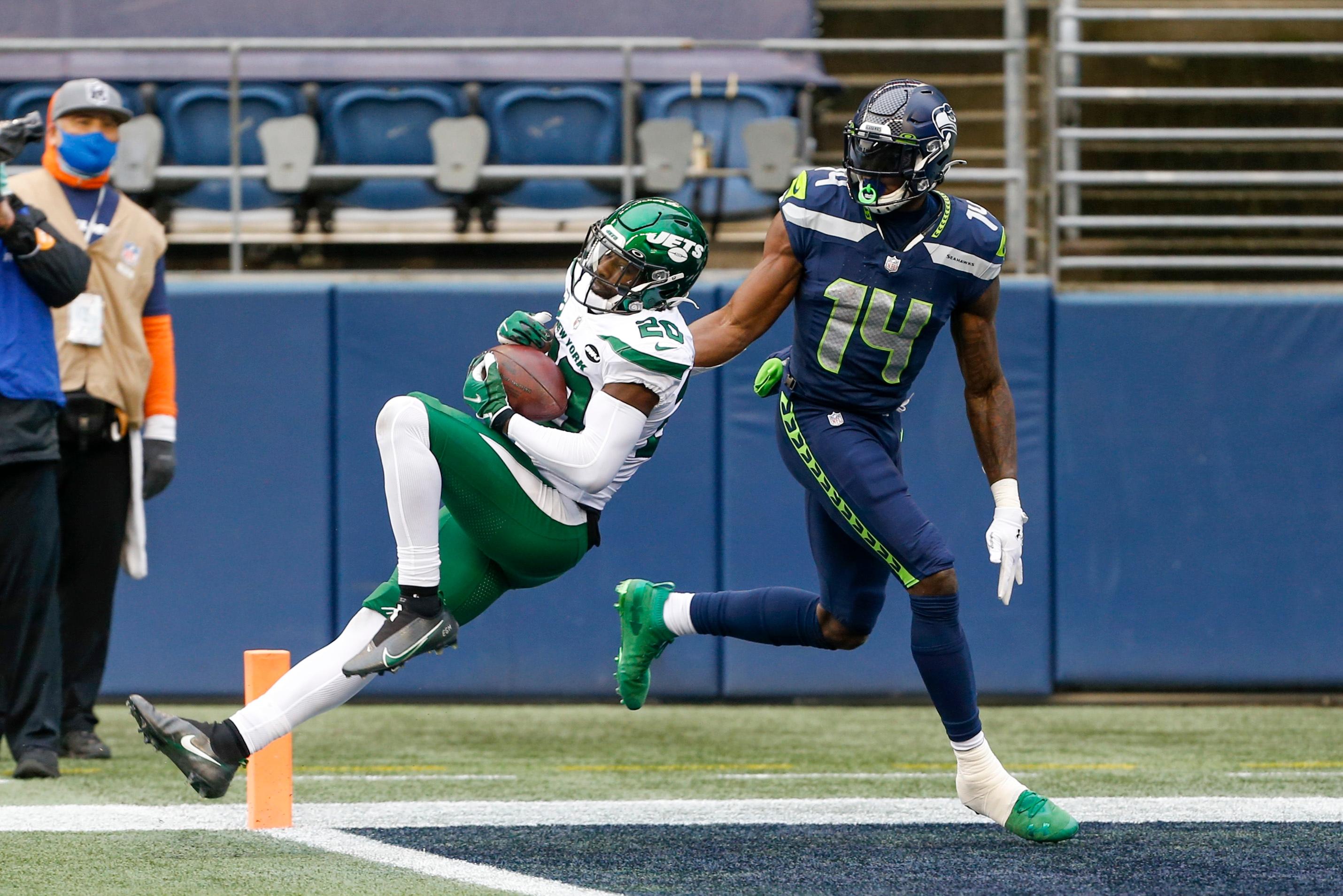 Dec 13, 2020; Seattle, Washington, USA; New York Jets free safety Marcus Maye (20) intercepts a pass intended for Seattle Seahawks wide receiver DK Metcalf (14) during the first quarter at Lumen Field. Mandatory Credit: Joe Nicholson-USA TODAY Sports / © Joe Nicholson-USA TODAY Sports