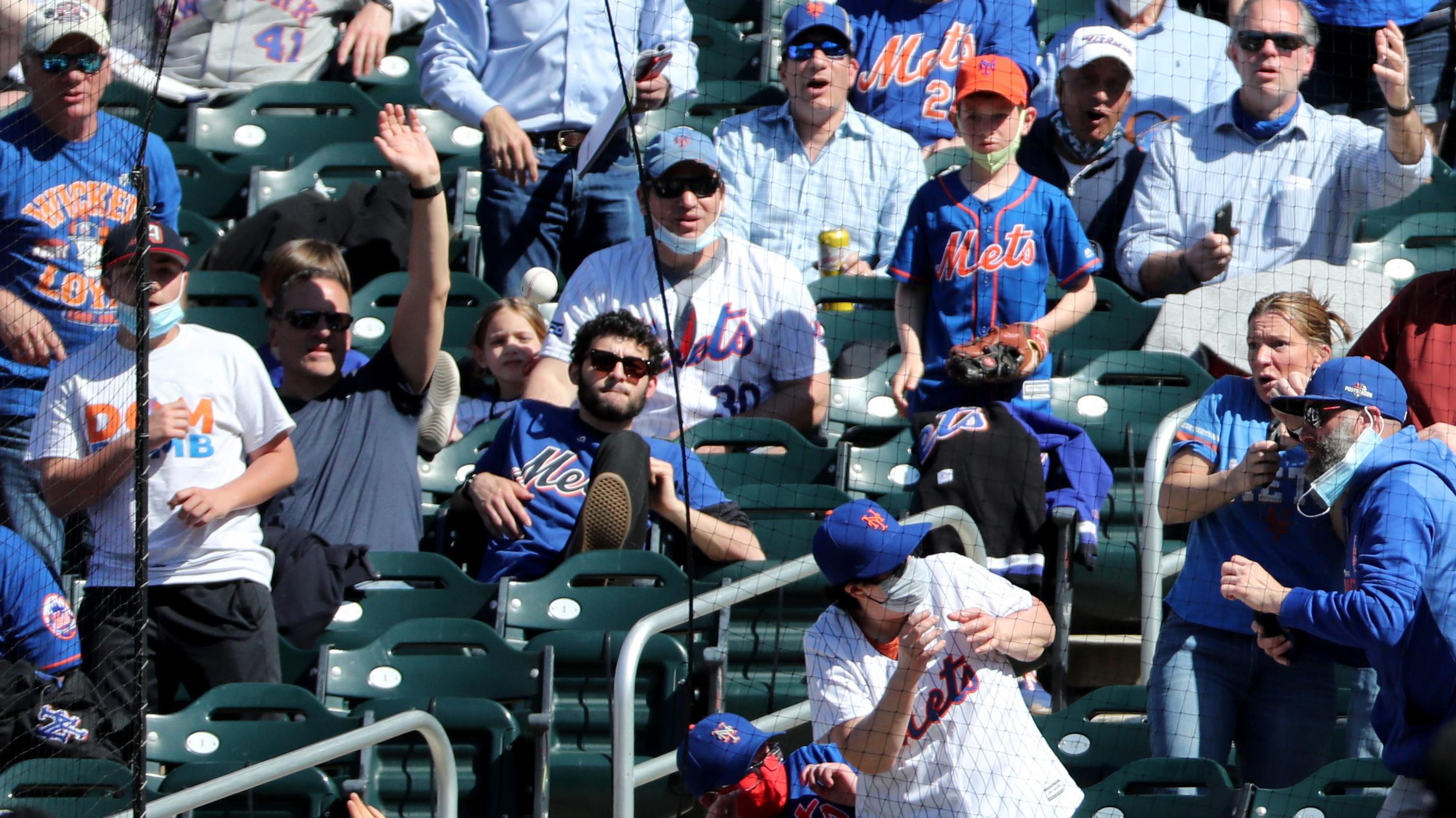 Some Mets fans try to reach a foul ball while others duck for cover. Thursday, April 8, 2021 Opening Day At Citi Field / Kevin R. Wexler-NorthJersey.com via Imagn Content Services, LLC