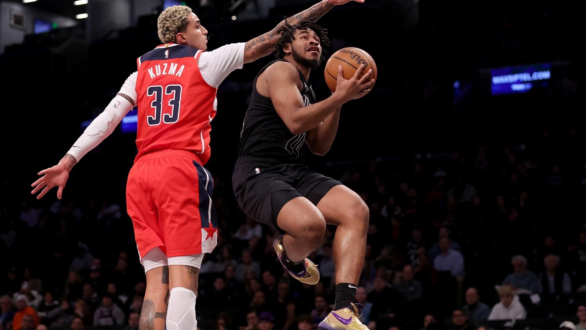 Dec 8, 2023; Brooklyn, New York, USA; Brooklyn Nets guard Cam Thomas (24) drives to the basket against Washington Wizards forward Kyle Kuzma (33) during the first quarter at Barclays Center. / Brad Penner-USA TODAY Sports