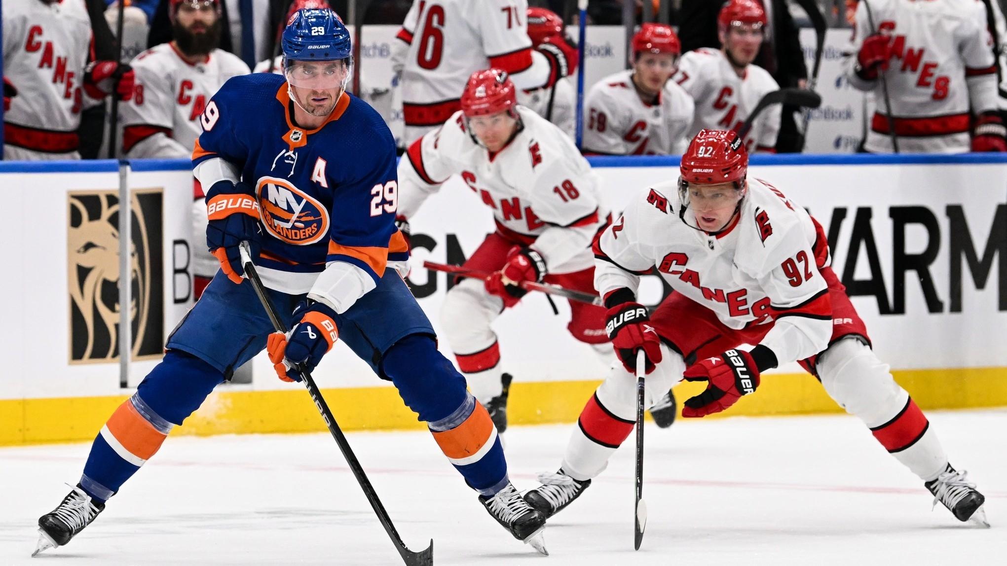 New York Islanders center Brock Nelson (29) skates with the puck chased by Carolina Hurricanes center Evgeny Kuznetsov (92) during the second period in game three of the first round of the 2024 Stanley Cup Playoffs at UBS Arena. / Dennis Schneidler-USA TODAY Sports