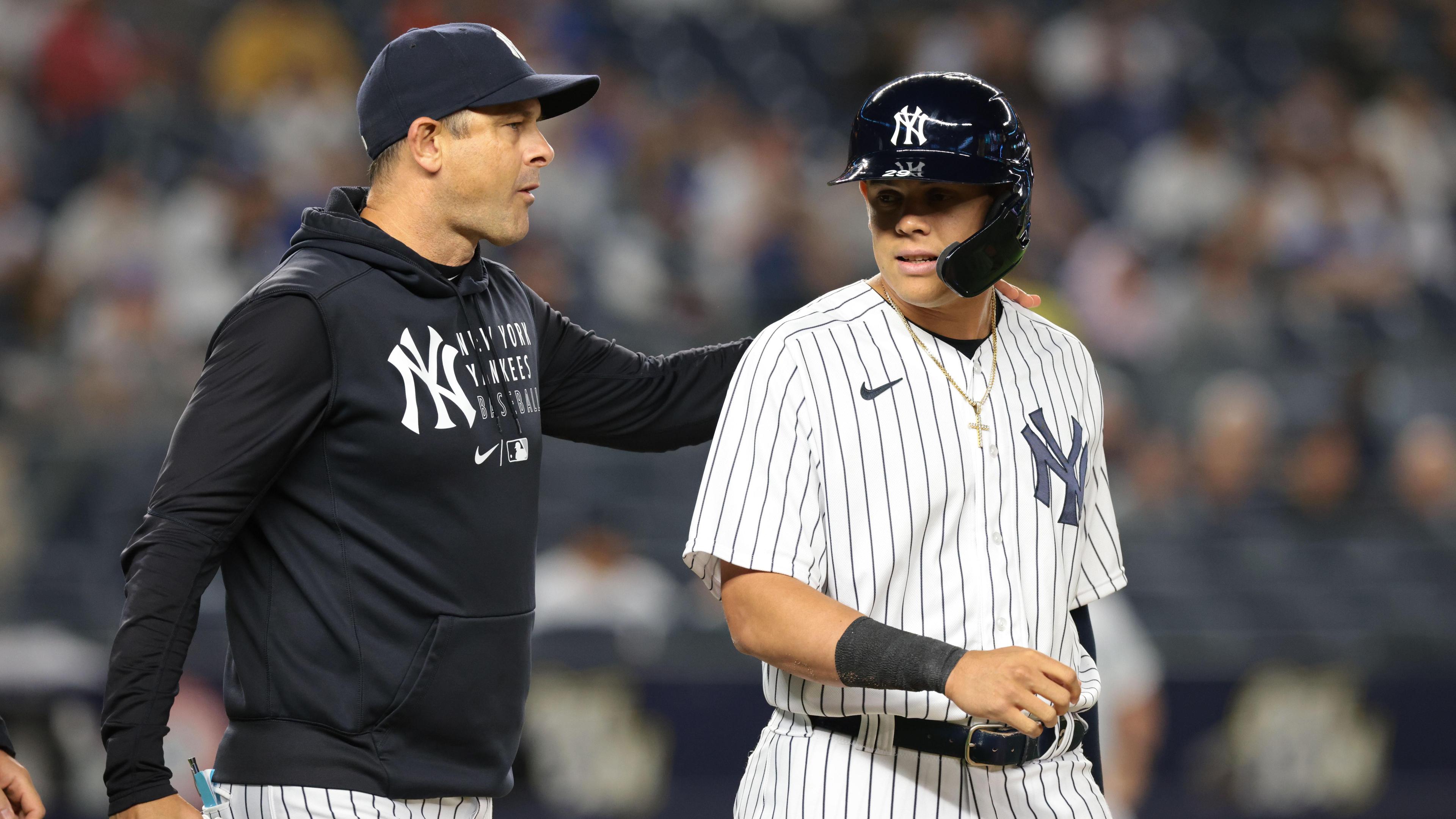 New York Yankees manager Aaron Boone (17) talks with third baseman Gio Urshela (29) during the seventh inning against the Kansas City Royals at Yankee Stadium. / Vincent Carchietta-USA TODAY Sports