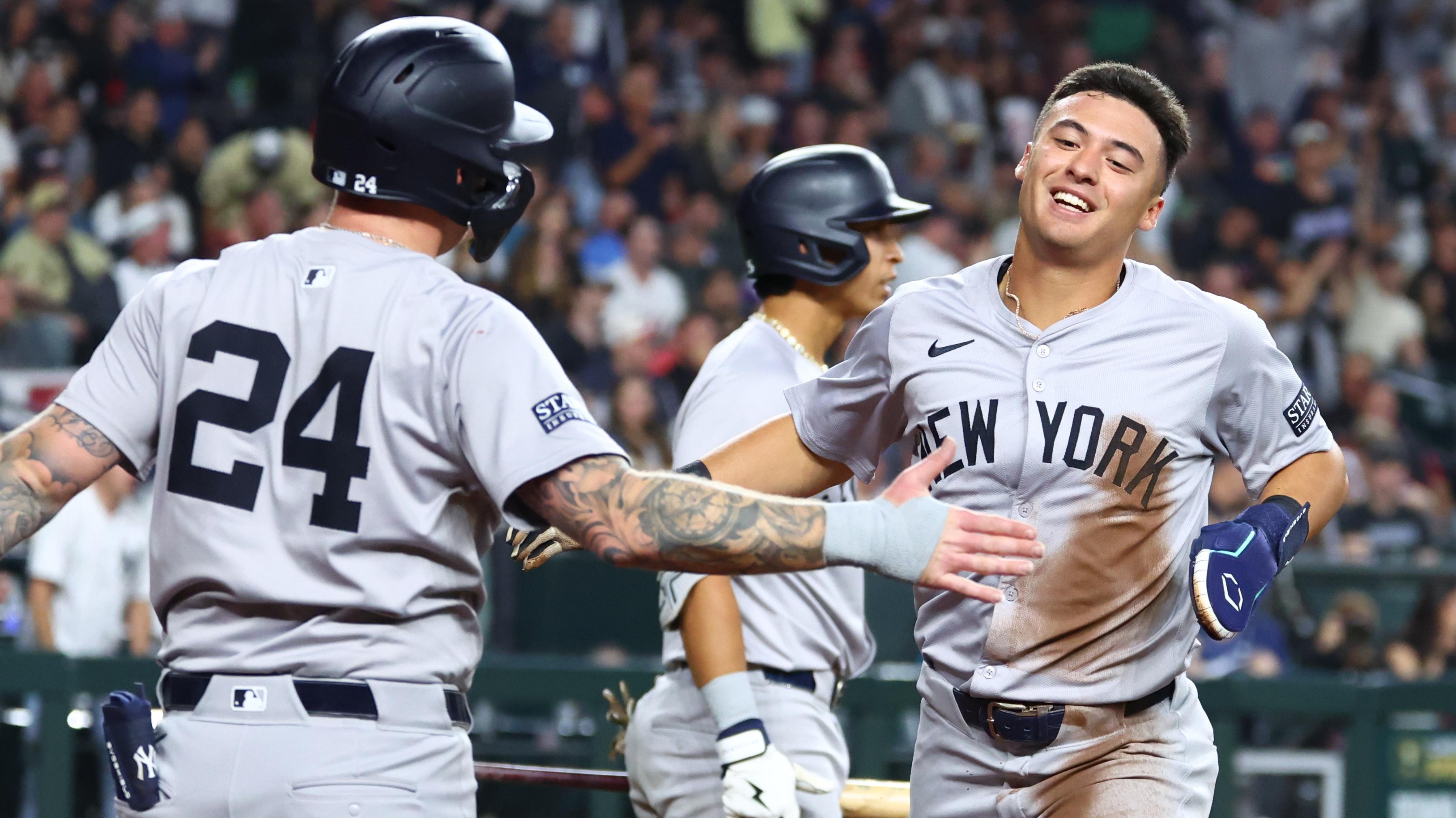 New York Yankees shortstop Anthony Volpe (right) celebrates with teammates after scoring against the Arizona Diamondbacks in the third inning at Chase Field / Mark J. Rebilas - USA TODAY Sports