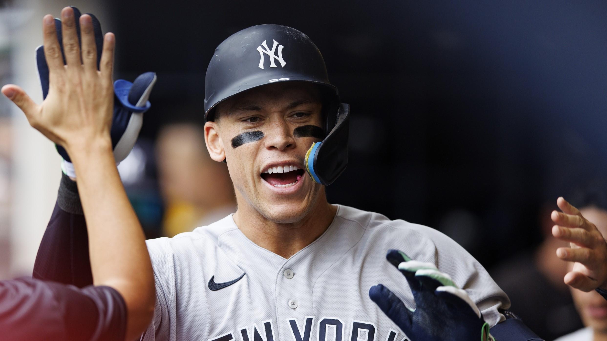 Sep 18, 2022; Milwaukee, Wisconsin, USA; New York Yankees center fielder Aaron Judge (99) high fives teammates after hitting a home run during the third inning against the Milwaukee Brewers at American Family Field. / Jeff Hanisch-USA TODAY Sports