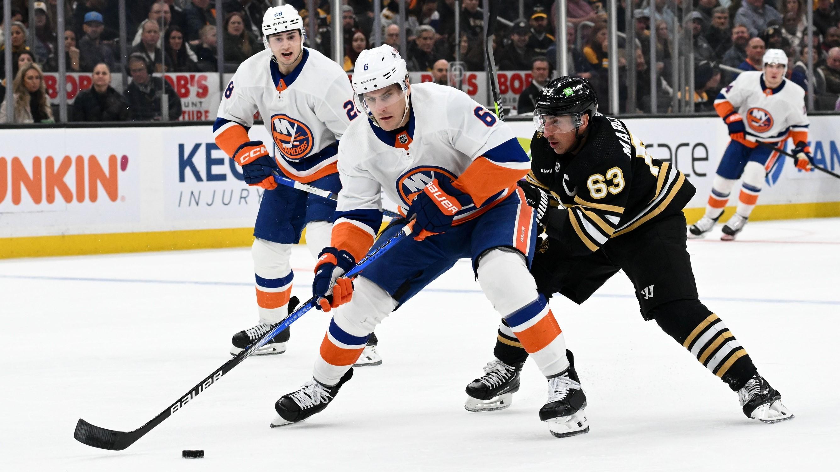 Nov 9, 2023; Boston, Massachusetts, USA; New York Islanders defenseman Ryan Pulock (6) controls the puck against Boston Bruins left wing Brad Marchand (63) during the first period at the TD Garden. / Brian Fluharty-USA TODAY Sports