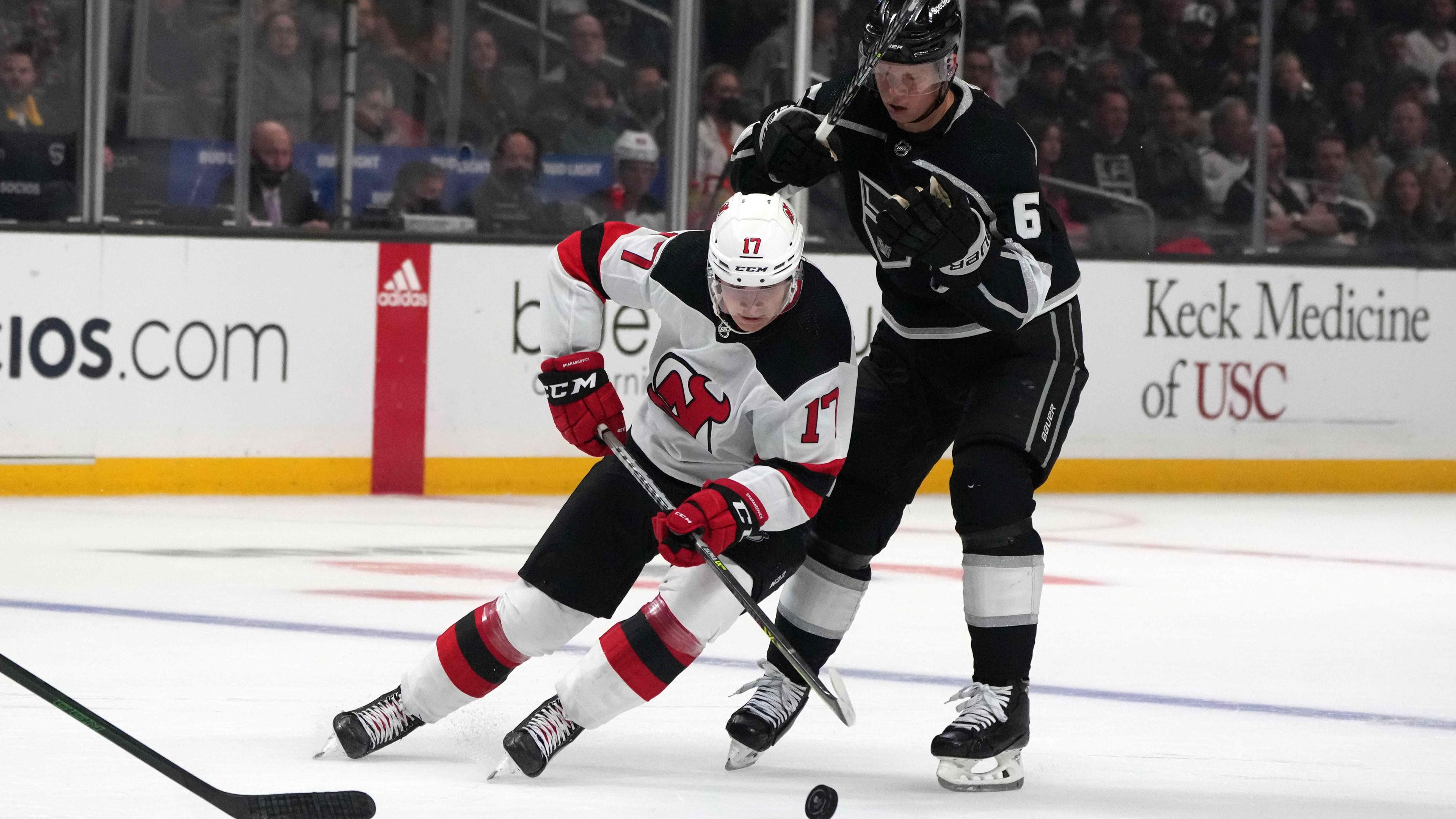 Nov 5, 2021; Los Angeles, California, USA; New Jersey Devils center Yegor Sharangovich (17) battles for the puck with LA Kings defenseman Olli Maatta (6) in the first period at Staples Center. / Kirby Lee-USA TODAY Sports