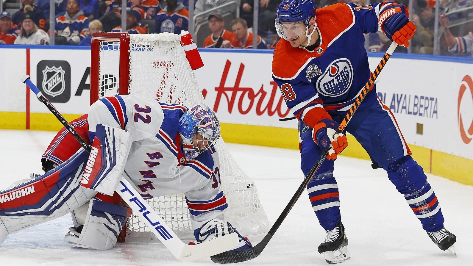 Oct 26, 2023; Edmonton, Alberta, CAN; New York Rangers goaltender Jonathan Quick (32) covers up a loose puck while Edmonton Oilers forward Zach Hyman (18) /looks for a rebound during the first period at Rogers Place / Perry Nelson-USA TODAY Sports