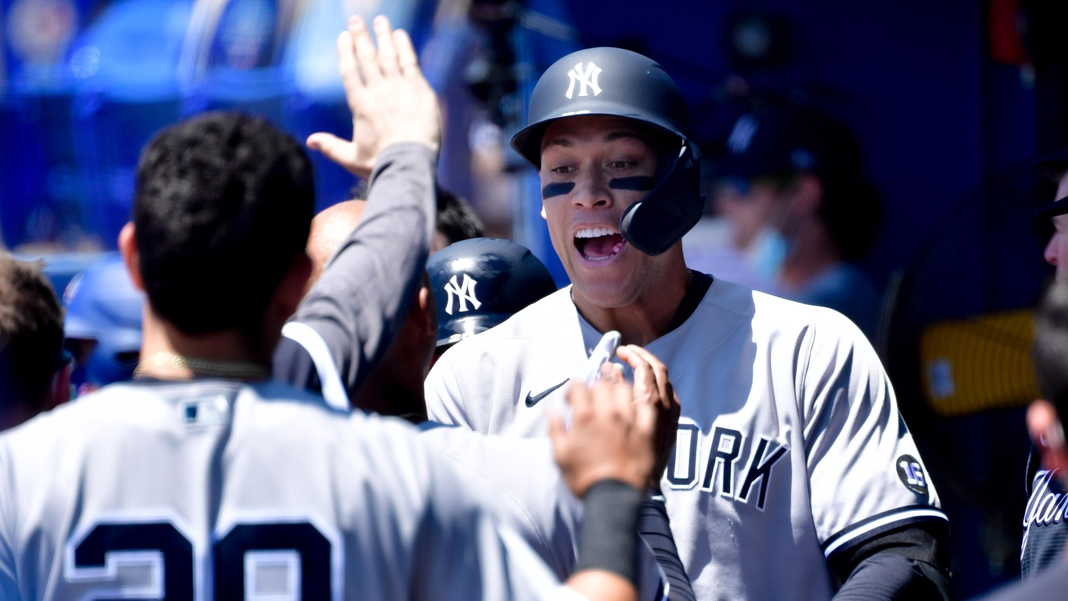 New York Yankees right fielder Aaron Judge (99) celebrates with teammates in the dugout after hitting a solo home run during the first inning against the Toronto Blue Jays at TD Ballpark. / Douglas DeFelice-USA TODAY Sports