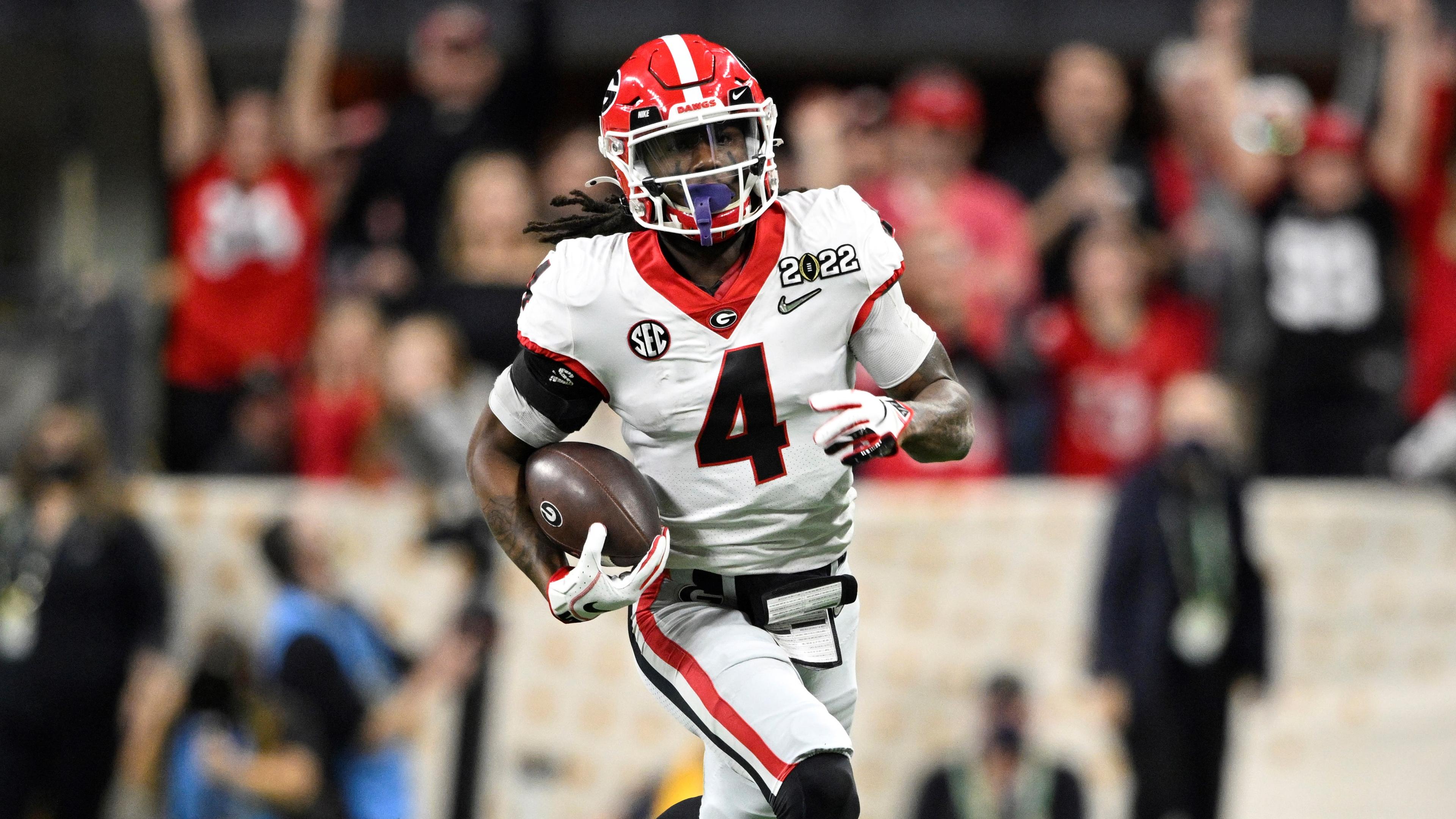 Georgia Bulldogs running back James Cook (4) runs the ball against the Alabama Crimson Tide in the third quarter during the 2022 CFP college football national championship game at Lucas Oil Stadium. / Marc Lebryk - USA TODAY Sports