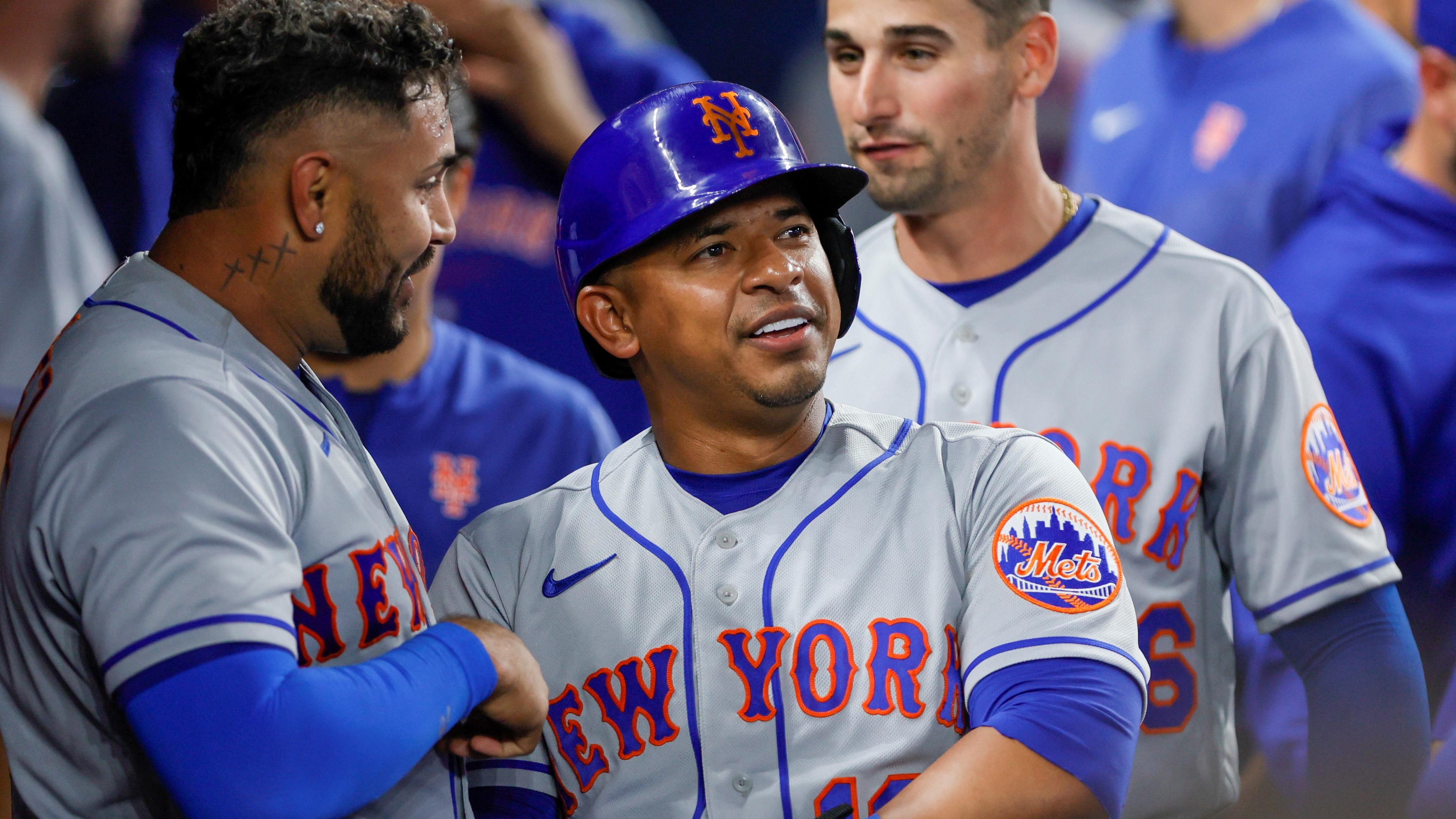 Mar 30, 2023; Miami, Florida, USA; New York Mets third baseman Eduardo Escobar (10) and catcher Omar Narvaez (2) celebrate in the dugout after scoring during the seventh inning against the Miami Marlins at loanDepot Park. Mandatory Credit: Sam Navarro-USA TODAY Sports / © Sam Navarro-USA TODAY Sports