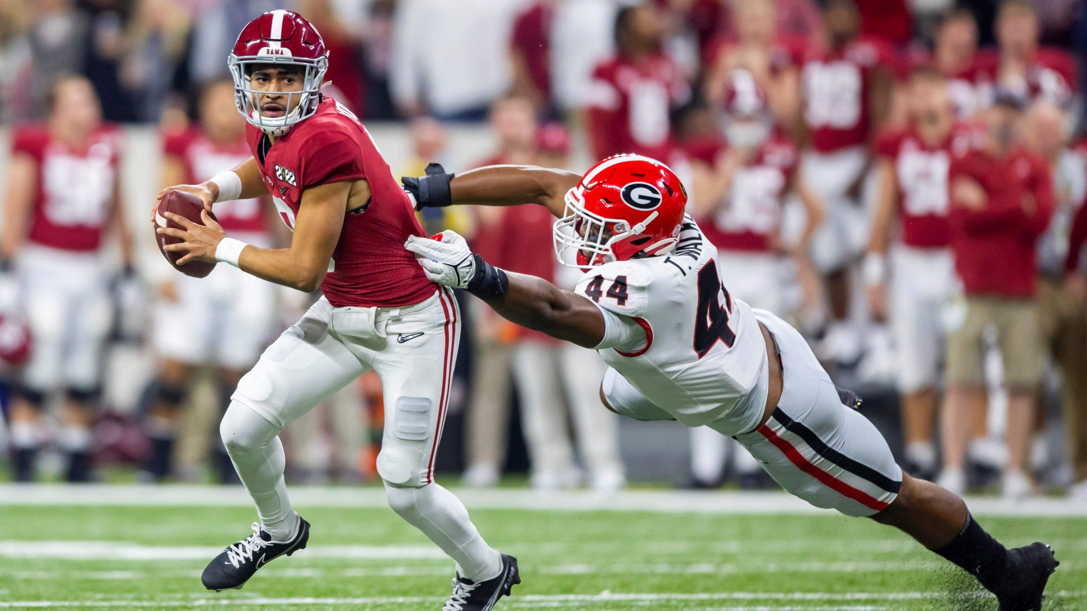 Alabama Crimson Tide quarterback Bryce Young (9) runs the ball against Georgia Bulldogs defensive lineman Travon Walker (44) during the first quarter in the 2022 CFP college football national championship game at Lucas Oil Stadium. / Mark J. Rebilas-USA TODAY Sports