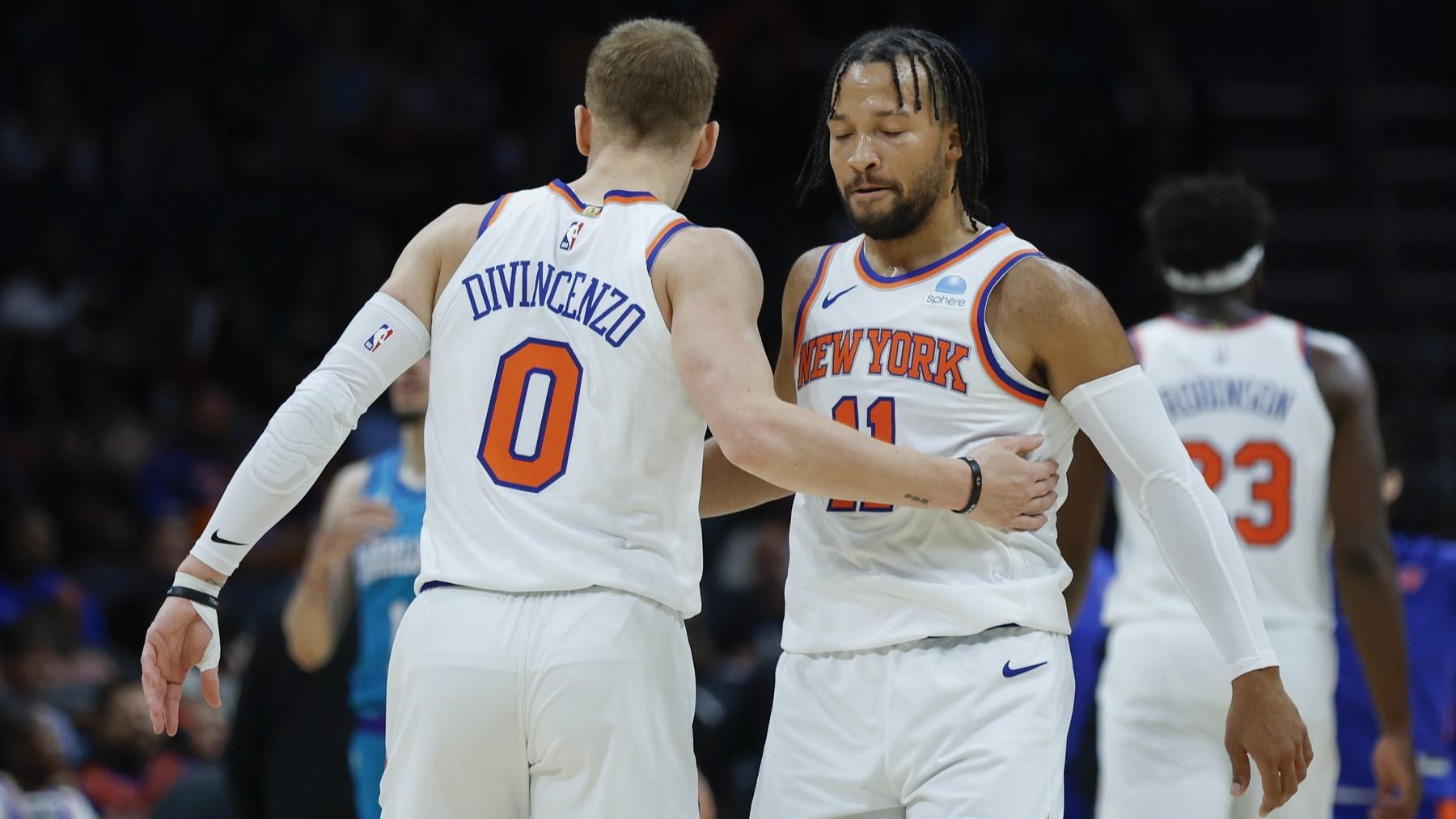 Nov 18, 2023; Charlotte, North Carolina, USA; New York Knicks guard Jalen Brunson (11) embraces guard Donte DiVincenzo (0) during the first quarter against the Charlotte Hornets at Spectrum Center. / Nell Redmond-USA TODAY Sports