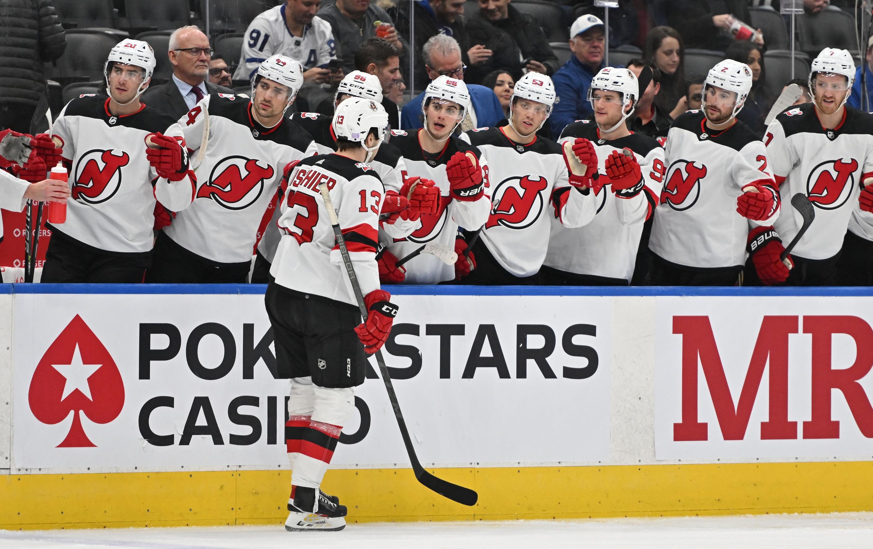 New Jersey Devils forward Nico Hischier (13) celebrates with teammates after scoring against the Toronto Maple Leafs in the second period at Scotiabank Arena. / Dan Hamilton-USA TODAY Sports