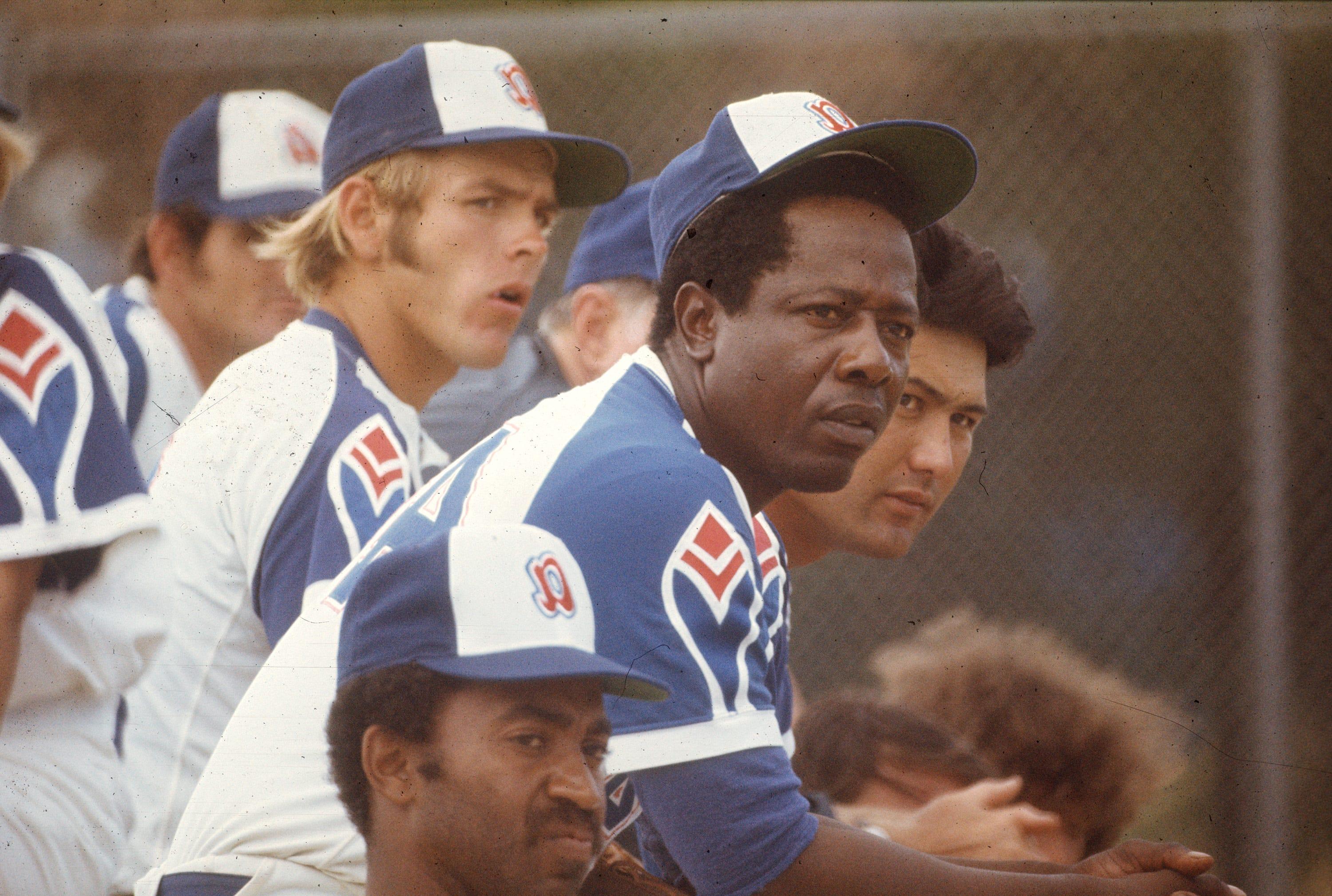 Hank Aaron watches a game from the dugout. / Guy Ferrell / The Palm Beach Post