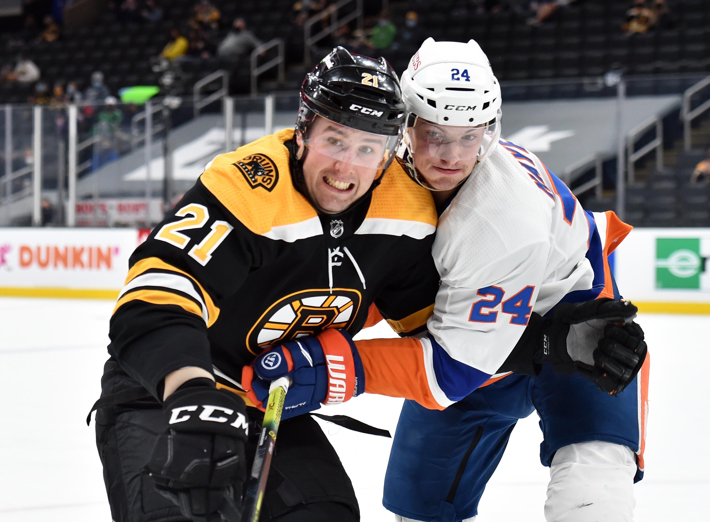 May 10, 2021; Boston, Massachusetts, USA; Boston Bruins left wing Nick Ritchie (21) and New York Islanders defenseman Nick Leddy (2) battle for position during the second period at TD Garden. Mandatory Credit: Bob DeChiara-USA TODAY Sports / Bob DeChiara-USA TODAY Sports