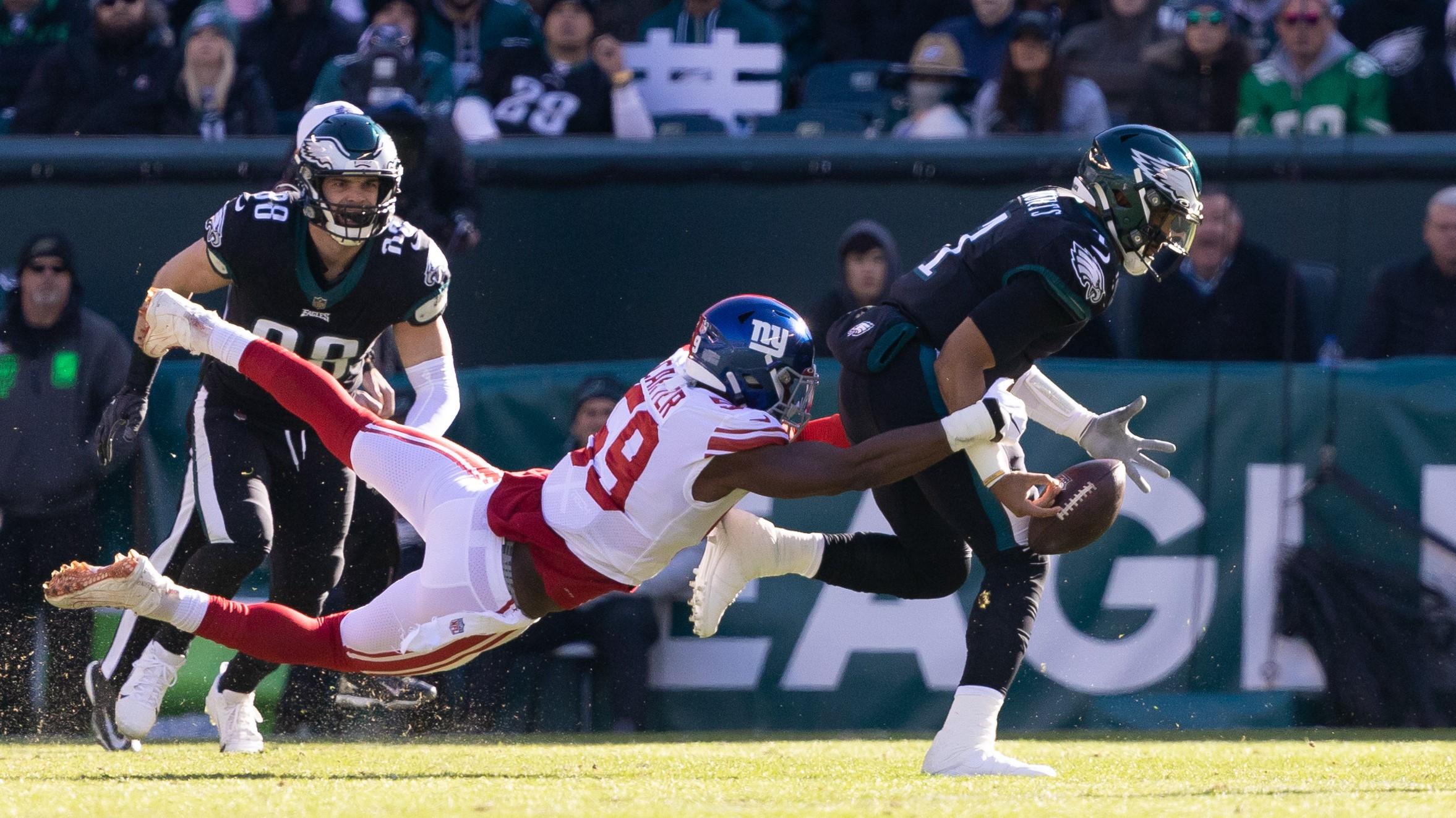 Dec 26, 2021; Philadelphia, Pennsylvania, USA; Philadelphia Eagles quarterback Jalen Hurts (1) fumbles the ball while being tackled by New York Giants outside linebacker Lorenzo Carter (59) during the first quarter at Lincoln Financial Field. / Bill Streicher-USA TODAY Sports