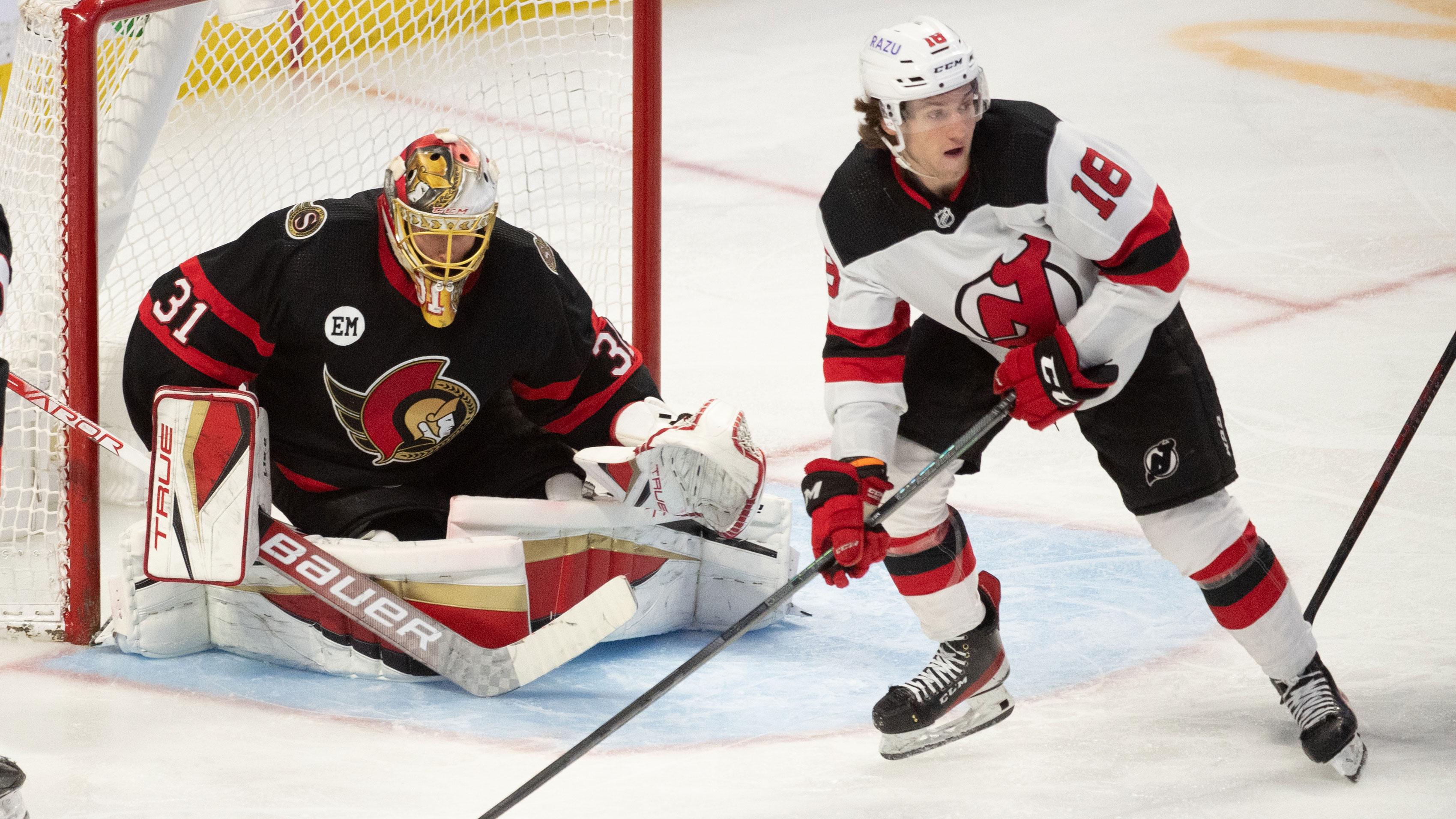 New Jersey Devils center Dawson Mercer (18) controls the puck in front of Ottawa Senators goalie Anton Forsberg (31) in the third period at the Canadian Tire Centre. / Marc DesRosiers-USA TODAY Sports
