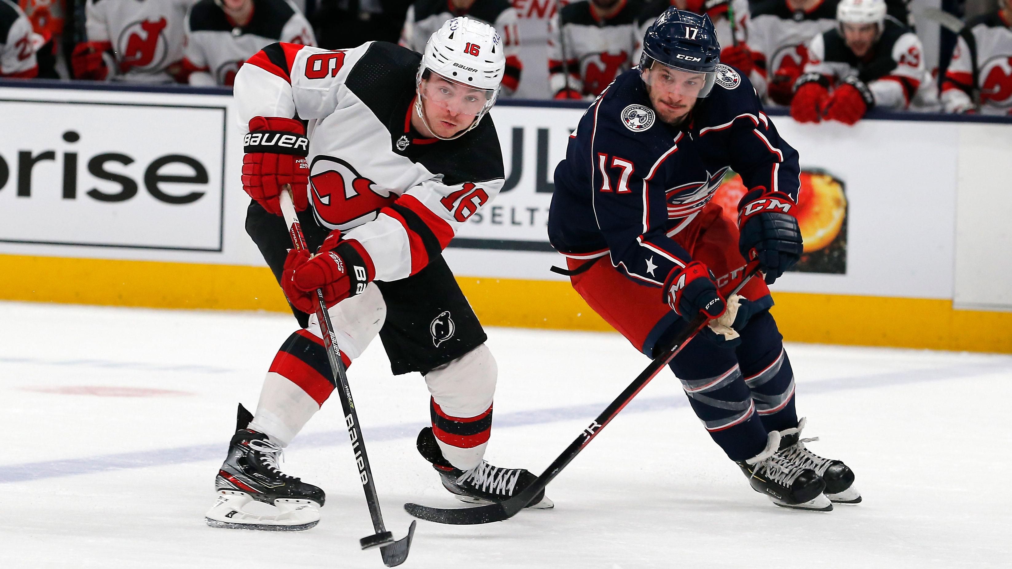 Mar 1, 2022; Columbus, Ohio, USA; New Jersey Devils left wing Jimmy Vesey (16) and Columbus Blue Jackets center Justin Danforth (17) chase down a loose puck during the second period at Nationwide Arena. / Russell LaBounty-USA TODAY Sports