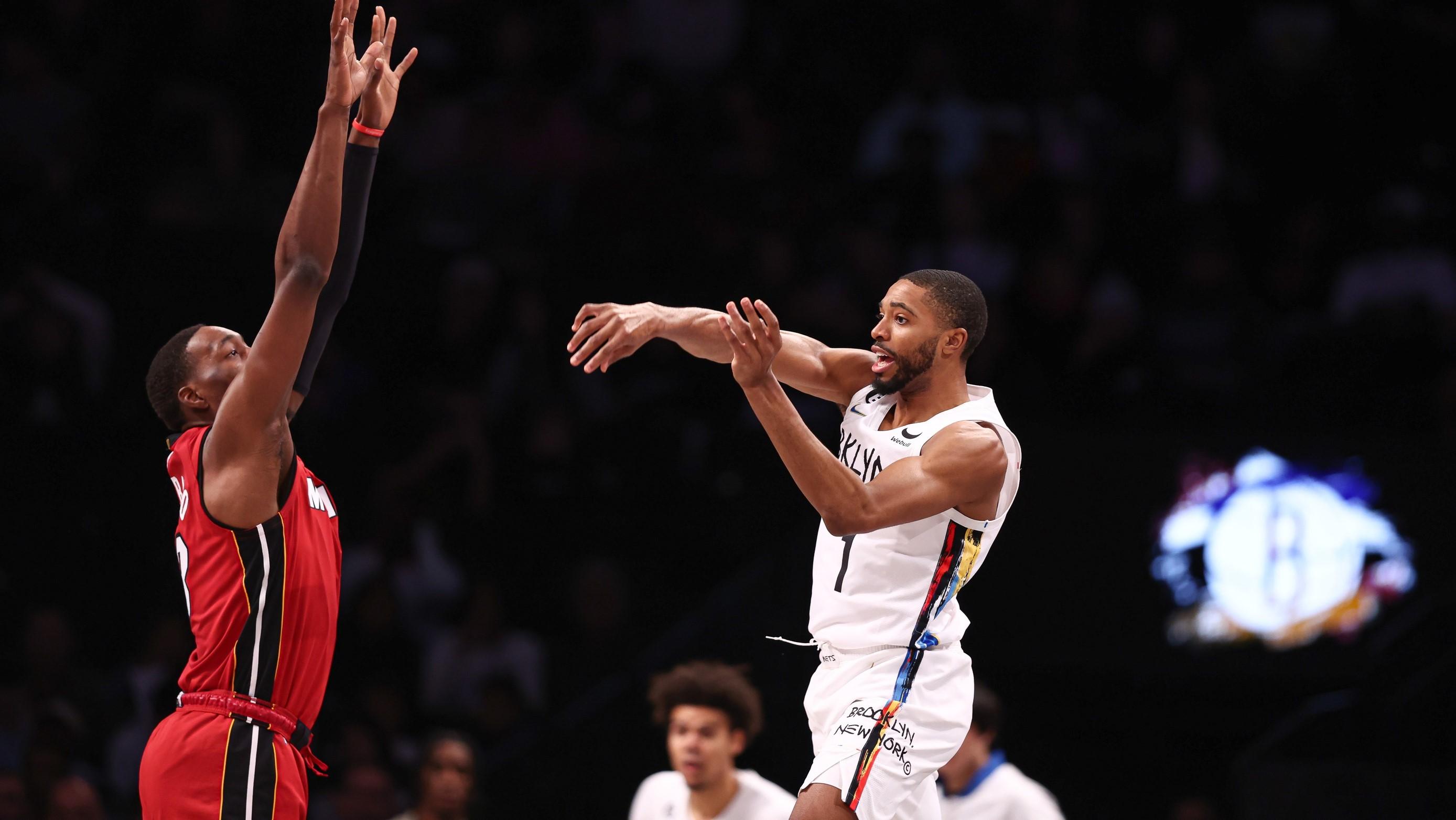 Feb 15, 2023; Brooklyn, New York, USA; Brooklyn Nets forward Mikal Bridges (1) passes the ball as Miami Heat center Bam Adebayo (13) defends during the first quarter at Barclays Center. / Vincent Carchietta-USA TODAY Sports
