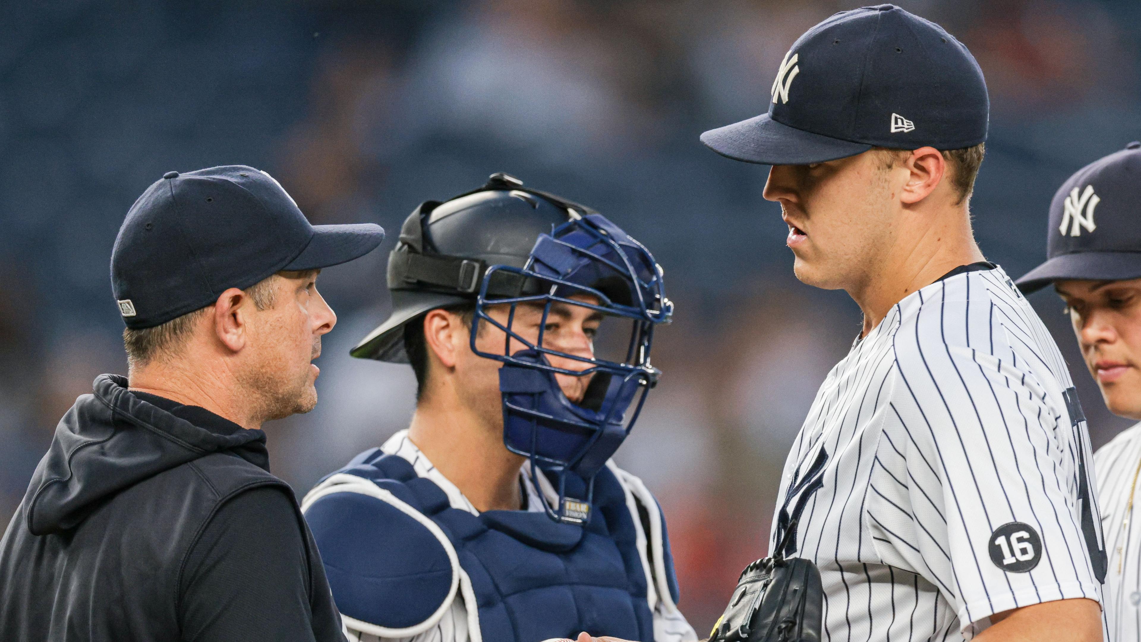 Jun 18, 2021; Bronx, New York, USA; New York Yankees starting pitcher Jameson Taillon (50) hands the ball to manager Aaron Boone (17) in front of catcher Kyle Higashioka (66) during the fifth inning against the Oakland Athletics at Yankee Stadium. Mandatory Credit: Vincent Carchietta-USA TODAY Sports / © Vincent Carchietta-USA TODAY Sports