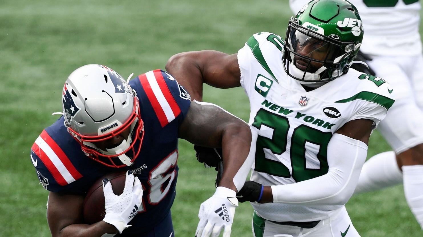 Jan 3, 2021; Foxborough, Massachusetts, USA; New England Patriots running back Sony Michel (26) rushes against New York Jets free safety Marcus Maye (20) during the first quarter at Gillette Stadium. / Brian Fluharty-USA TODAY Sports