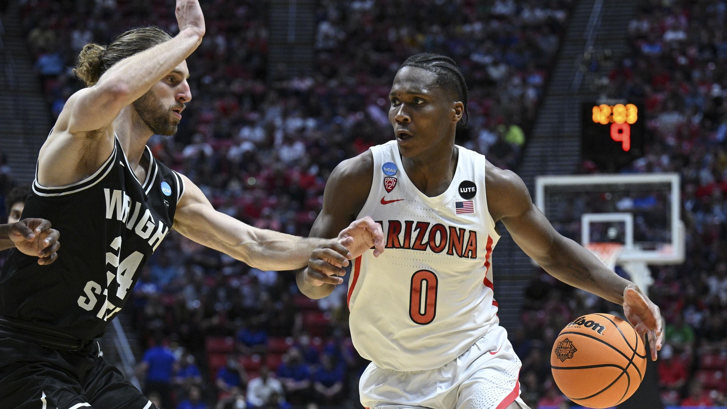 Mar 18, 2022; San Diego, CA, USA; Arizona Wildcats guard Bennedict Mathurin (0) dribbles the basketball against Wright State Raiders guard Tim Finke (24) during the second half during the first round of the 2022 NCAA Tournament at Viejas Arena. / Orlando Ramirez-USA TODAY Sports