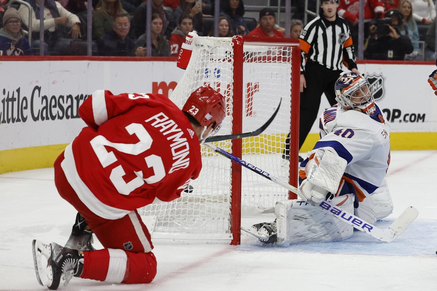 Detroit Red Wings left wing Lucas Raymond (23) scores a goal on New York Islanders goaltender Semyon Varlamov (40) in the second period at Little Caesars Arena. / Rick Osentoski-USA TODAY Sports