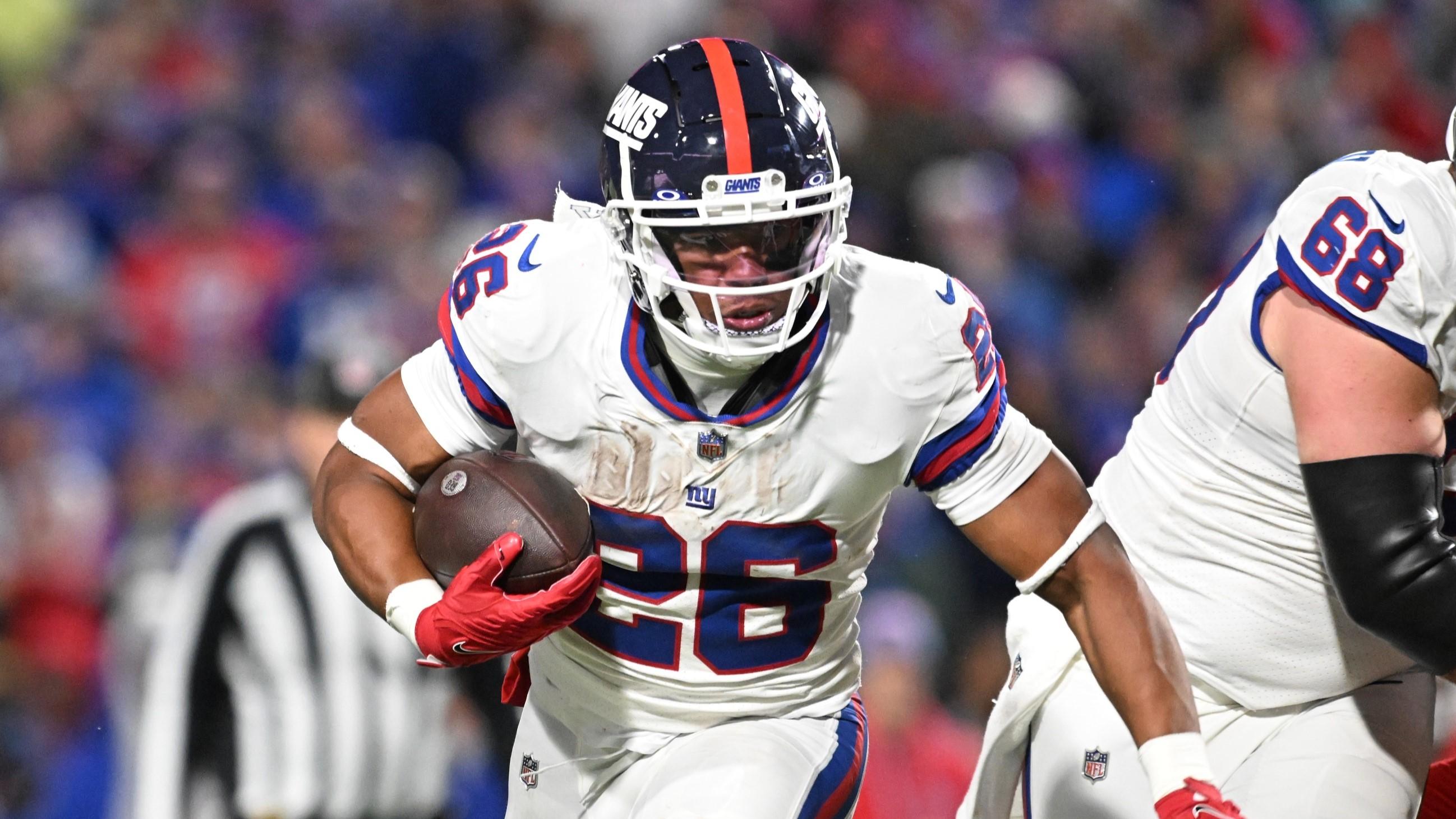 Oct 15, 2023; Orchard Park, New York, USA; New York Giants running back Saquon Barkley (26) carries the ball against the Buffalo Bills in the fourth quarter at Highmark Stadium. / Mark Konezny-USA TODAY Sports