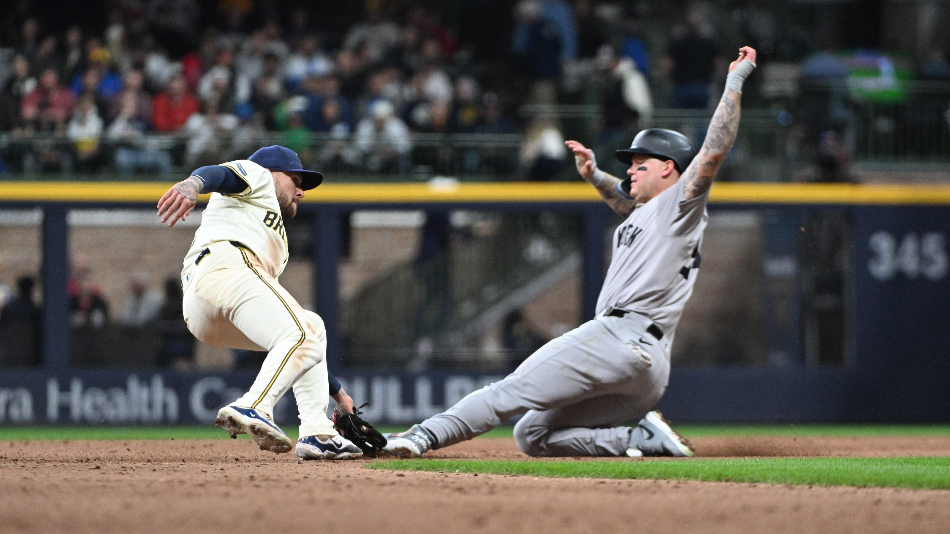 Apr 26, 2024; Milwaukee, Wisconsin, USA; Milwaukee Brewers second base Brice Turang (2) tags out Alex Verdugo (24) on an attempted steal in the ninth inning at American Family Field. / Michael McLoone-USA TODAY Sports