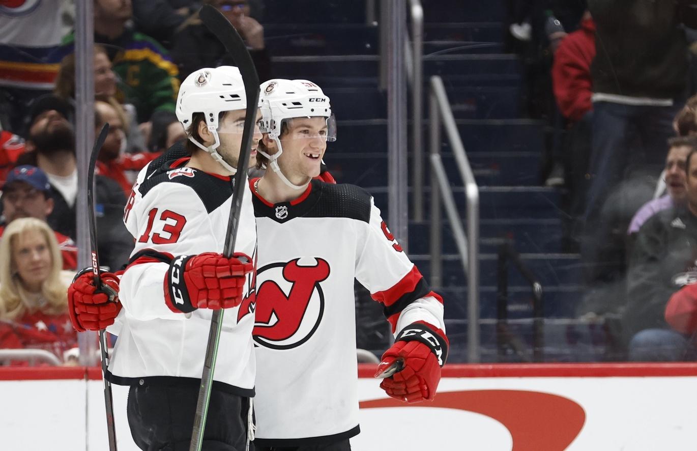 New Jersey Devils center Dawson Mercer (91) celebrates with Devils center Nico Hischier (13) after scoring a goal against the Washington Capitals in the second period at Capital One Arena. / Geoff Burke-USA TODAY Sports