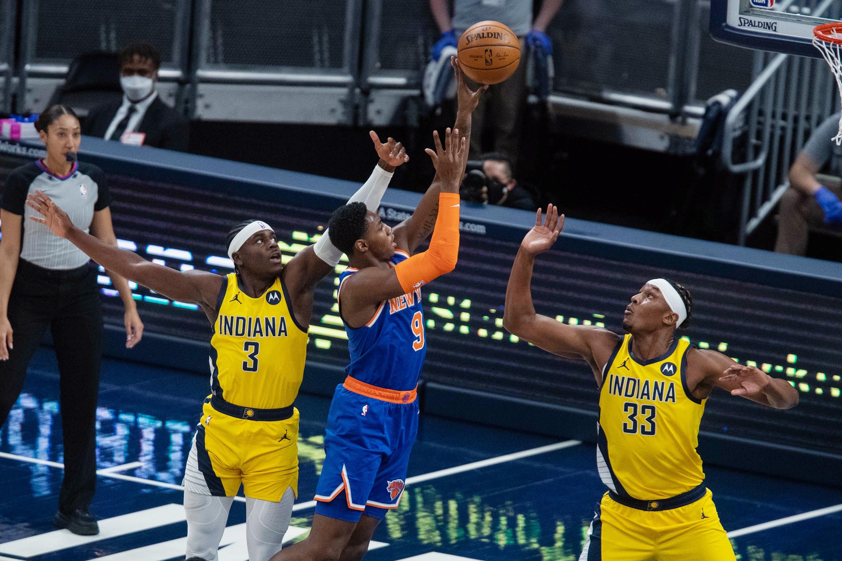 Jan 2, 2021; Indianapolis, Indiana, USA; New York Knicks guard RJ Barrett (9) shoots the ball against Indiana Pacers guard Aaron Holiday (3) and center Myles Turner (33) in the first quarter at Bankers Life Fieldhouse. / Trevor Ruszkowski-USA TODAY Sports