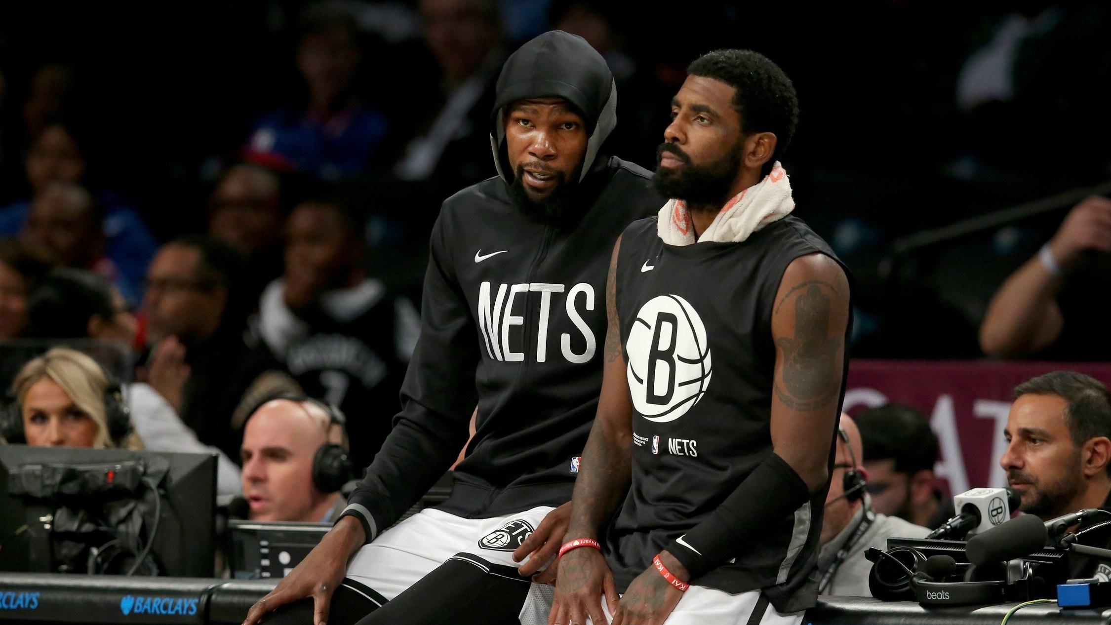 Brooklyn Nets forward Kevin Durant (7) and guard Kyrie Irving (11) wait to check into the game against the Philadelphia 76ers. / Brad Penner-USA TODAY Sports