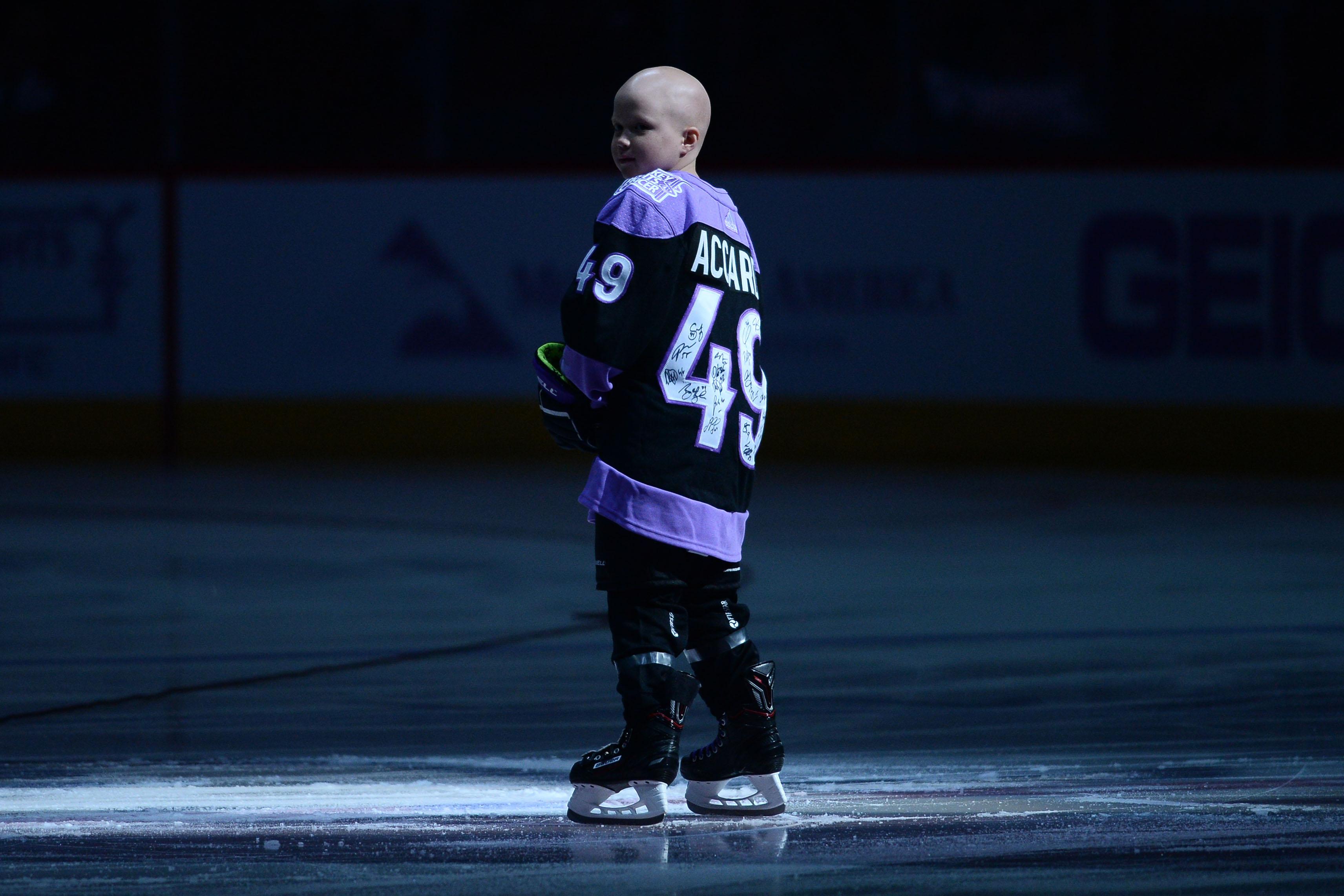 Nov 16, 2019; Glendale, AZ, USA; Cancer patient Leighton Accardo joins the Arizona Coyotes during the national anthems prior the first period against the Calgary Flames at Gila River Arena. / Joe Camporeale-USA TODAY Sports