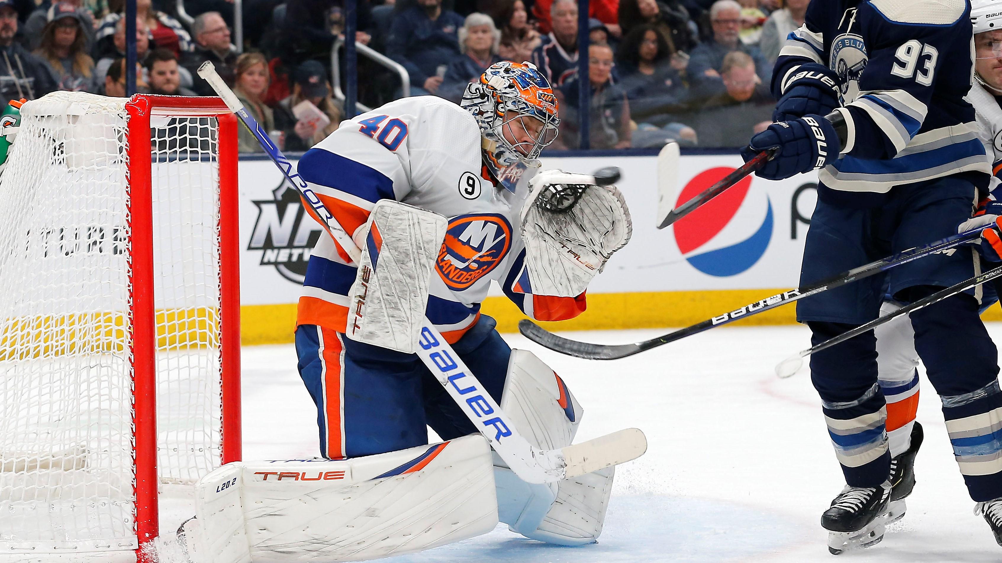 Mar 29, 2022; Columbus, Ohio, USA; New York Islanders goalie Semyon Varlamov (40) makes a save as Columbus Blue Jackets right wing Jakub Voracek (93) reaches for the puckduring the second period at Nationwide Arena. Mandatory Credit: Russell LaBounty-USA TODAY Sports / Russell LaBounty-USA TODAY Sports