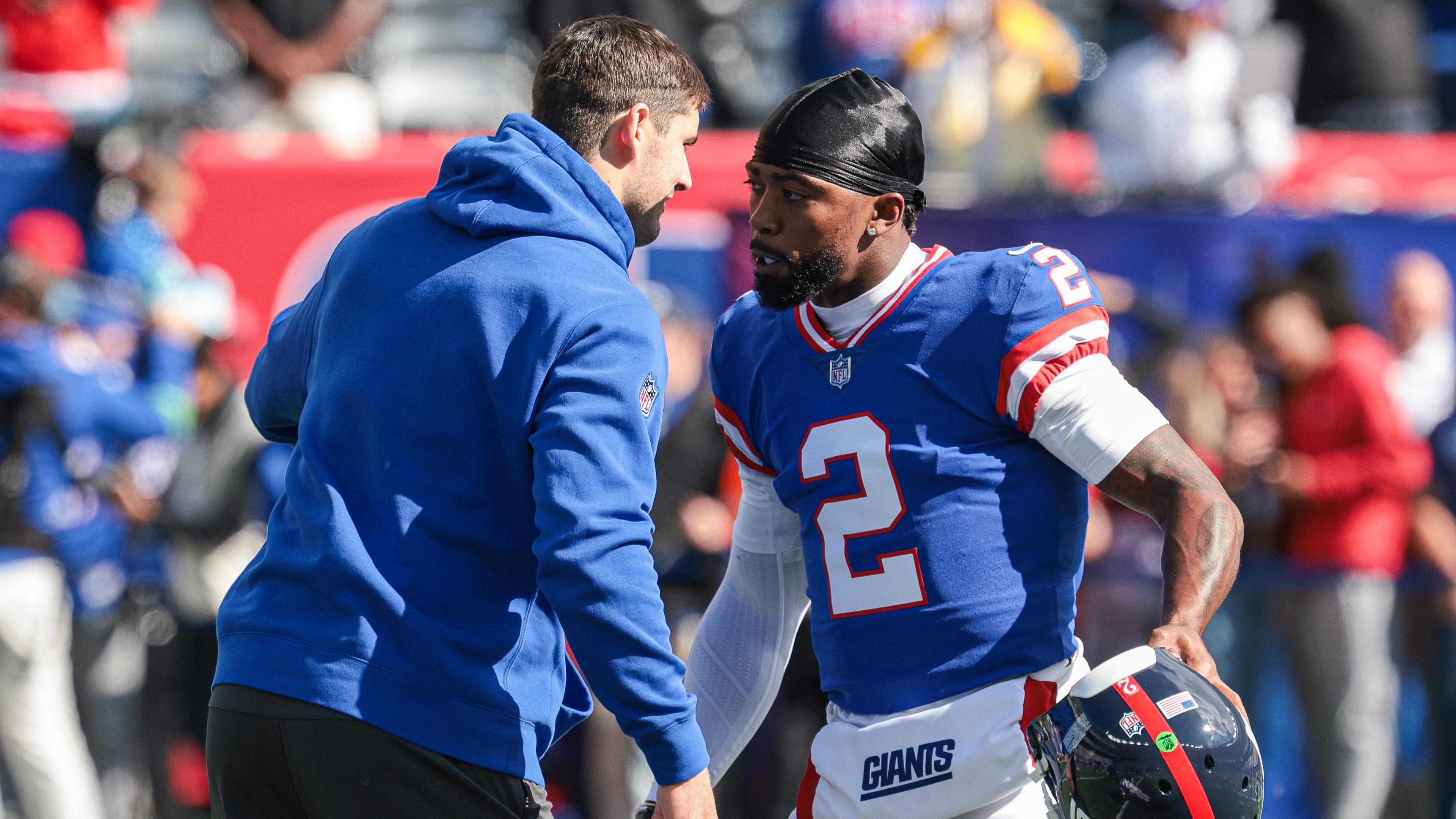 Oct 22, 2023; East Rutherford, New Jersey, USA; New York Giants quarterback Daniel Jones (left) talks with quarterback Tyrod Taylor (2) before the game against the Washington Commanders at MetLife Stadium. Mandatory Credit: Vincent Carchietta-USA TODAY Sports / © Vincent Carchietta-USA TODAY Sports