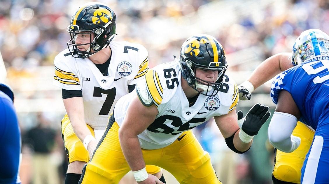 Iowa quarterback Spencer Petras (7) takes a snap from center Tyler Linderbaum (65) during a NCAA college football game in the Vrbo Citrus Bowl against Kentucky, Saturday, Jan. 1, 2022, at Camping World Stadium in Orlando, Fla. / Joseph Cress/Iowa City Press-Citizen / USA TODAY NETWORK