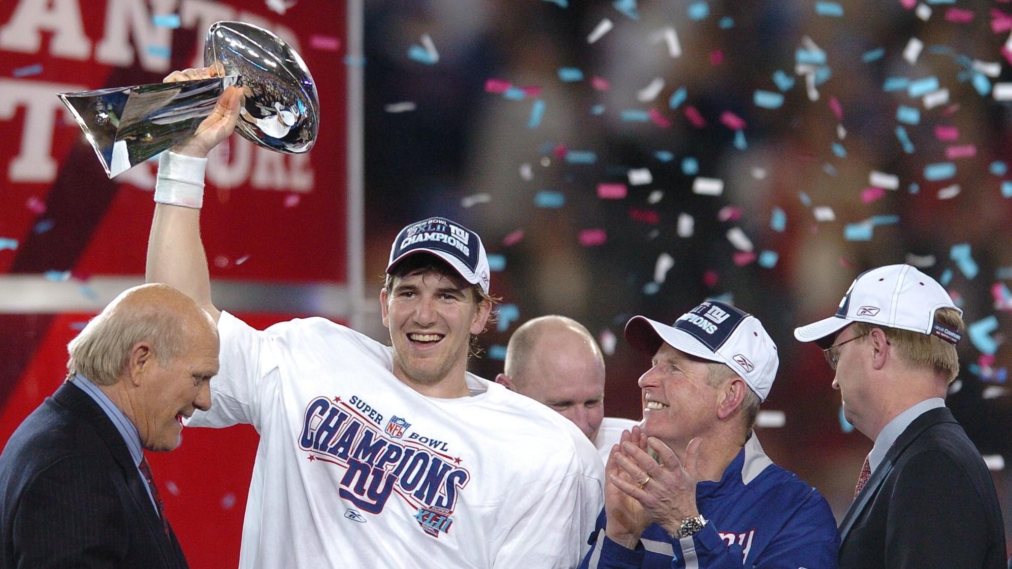Eli Manning holds the trophy after Super Bowl XLII. / TYSON TRISH/THE RECORD