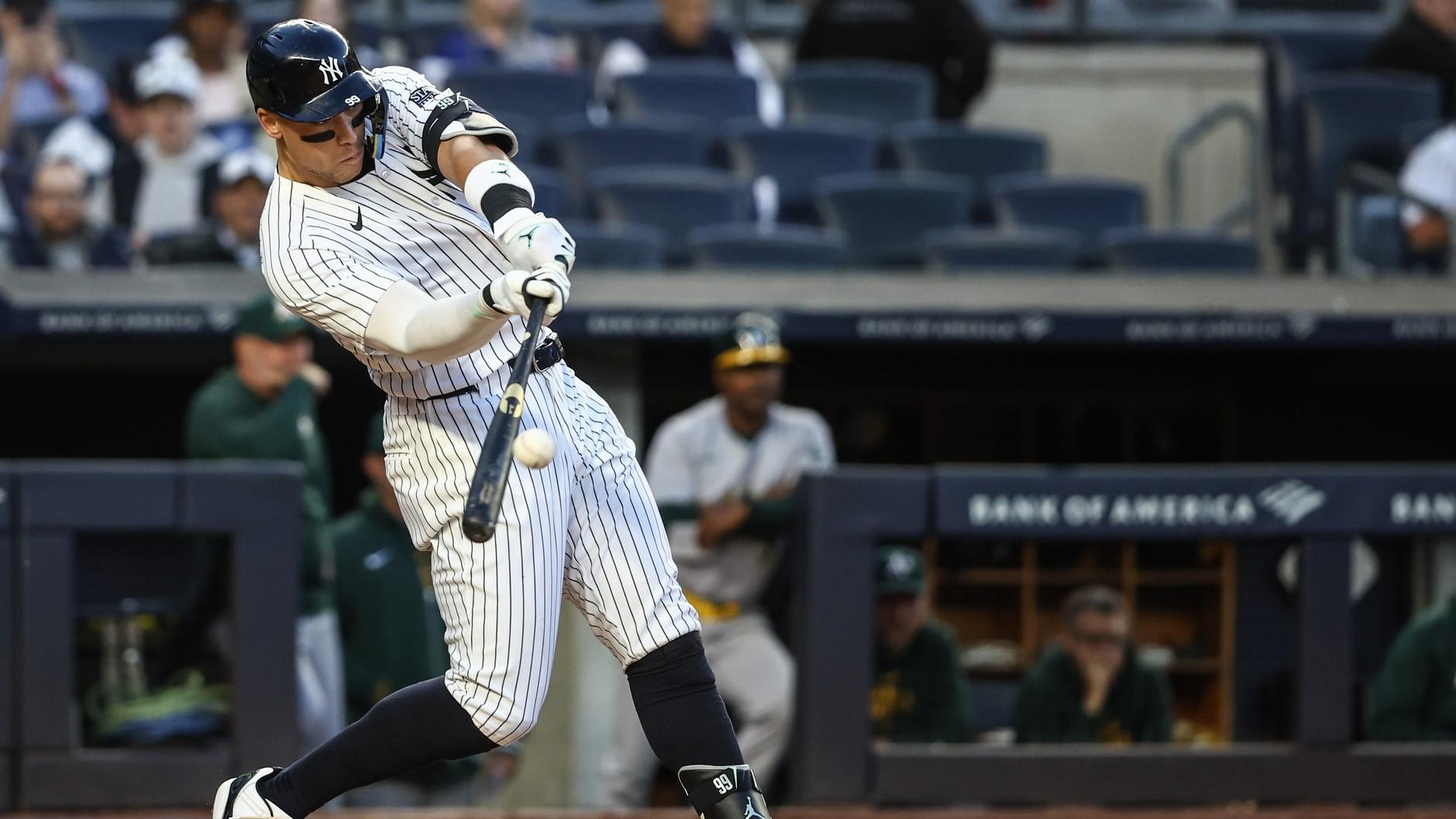 Apr 24, 2024; Bronx, New York, USA; New York Yankees center fielder Aaron Judge (99) hits a two run home run in the first inning against the Oakland Athletics at Yankee Stadium. / Wendell Cruz-USA TODAY Sports