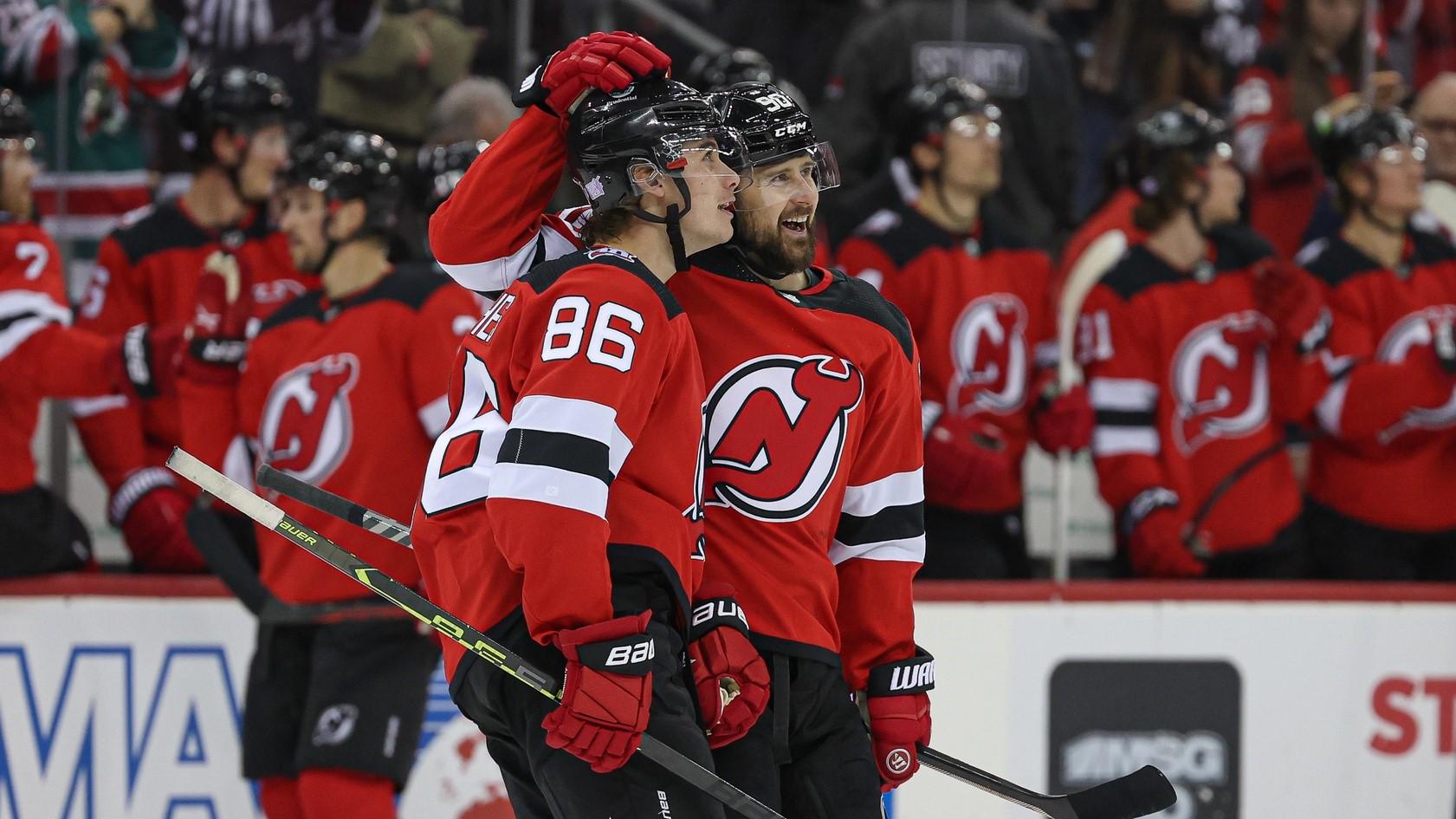 Nov 12, 2022; Newark, New Jersey, USA; New Jersey Devils center Jack Hughes (86) and left wing Tomas Tatar (90) look up at the main scoreboard after a goal against the Arizona Coyotes during the first period at Prudential Center. / Vincent Carchietta-USA TODAY Sports