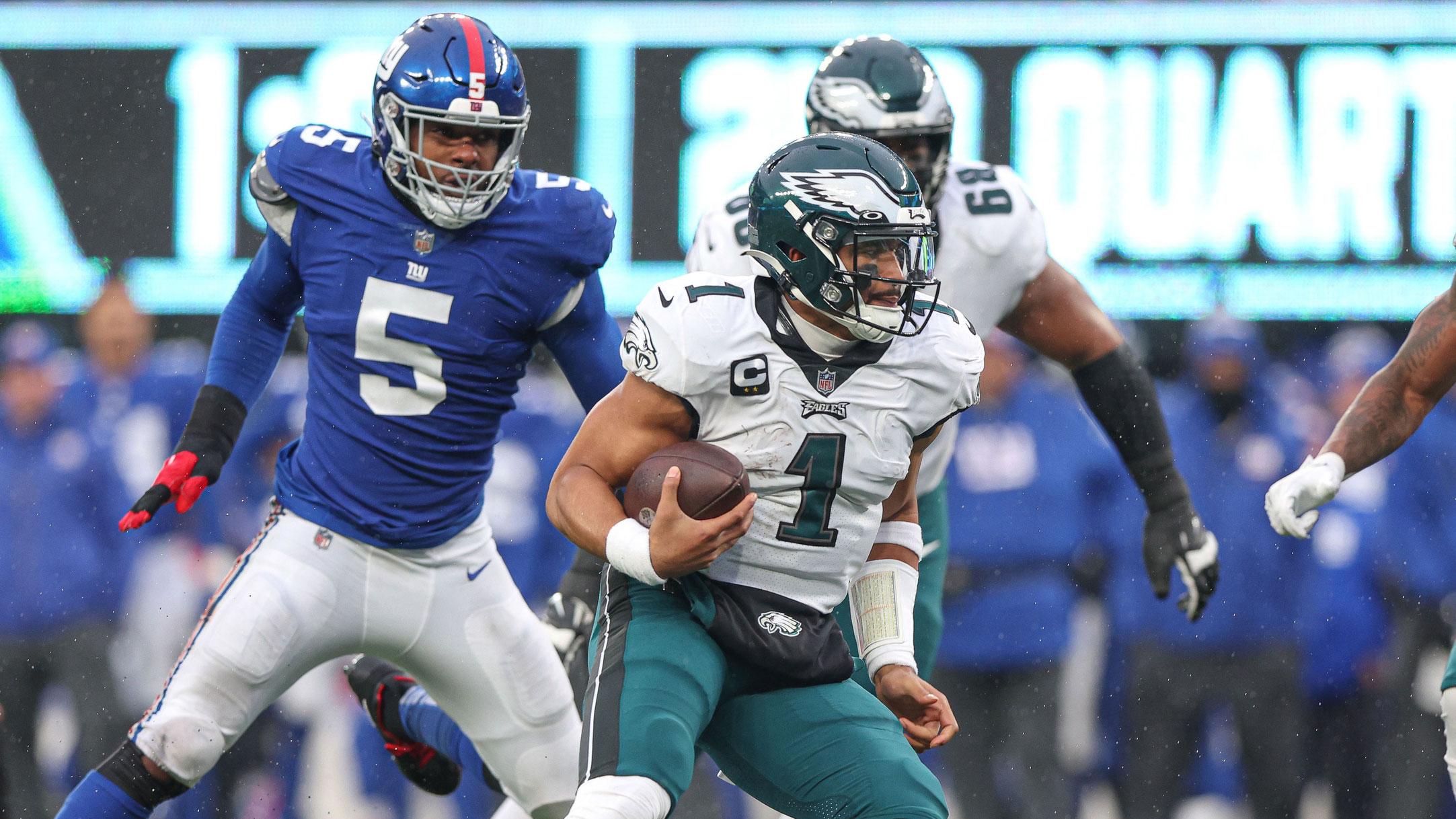 Dec 11, 2022; East Rutherford, New Jersey, USA; Philadelphia Eagles quarterback Jalen Hurts (1) scrambles for yards in front of New York Giants defensive end Kayvon Thibodeaux (5) during the first half at MetLife Stadium. / Vincent Carchietta-USA TODAY Sports