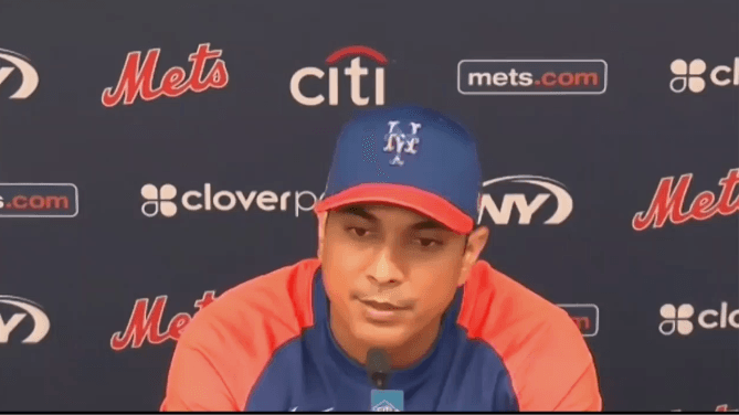 Luis Rojas speaks in front of step and repeat at spring training February 2021 / Mets manager Luis Rojas