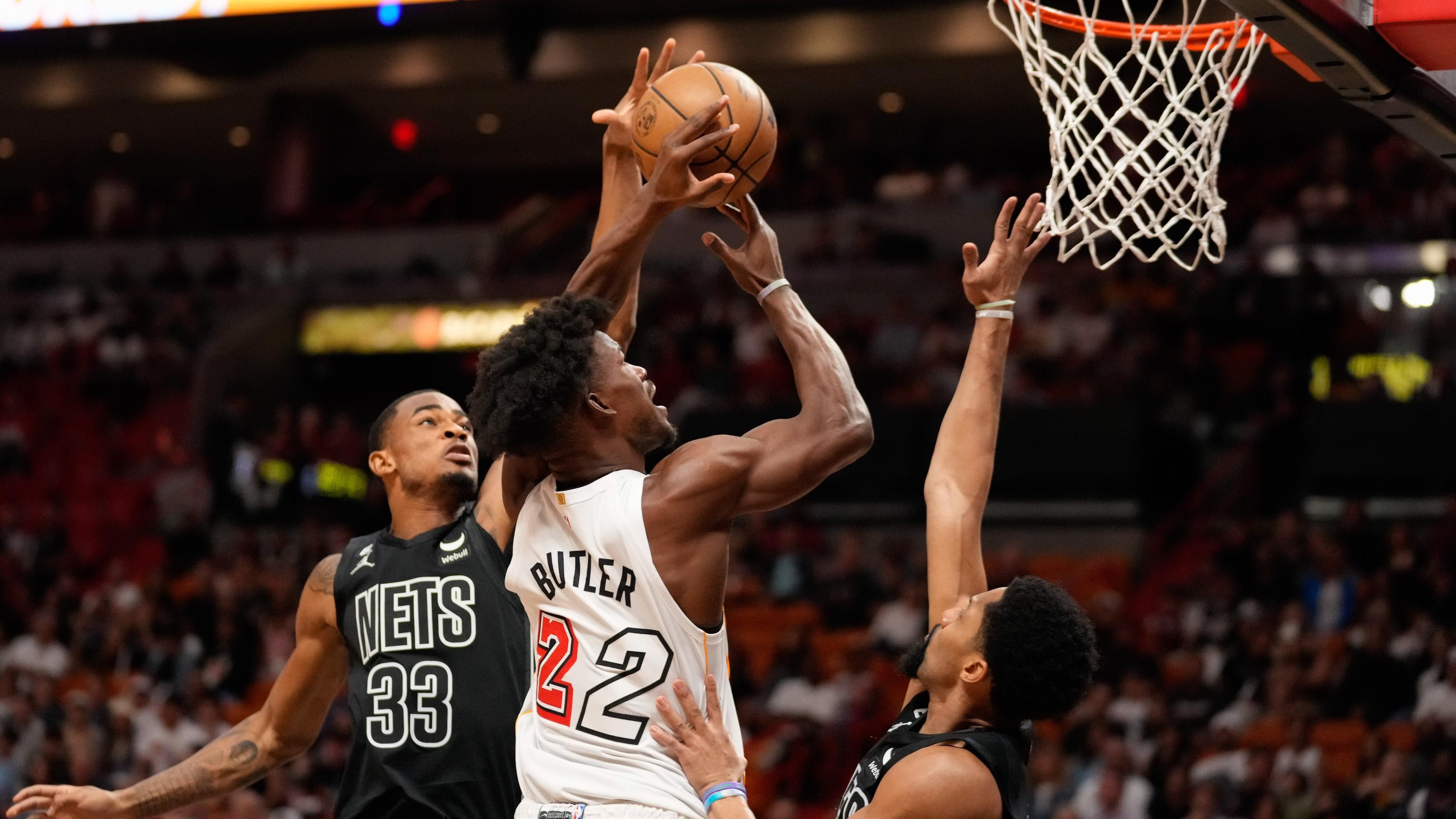 Mar 25, 2023; Miami, Florida, USA; Brooklyn Nets center Nic Claxton (33) fouls Miami Heat forward Jimmy Butler (22) during the first quarter at Miami-Dade Arena. / Rich Storry-USA TODAY Sports