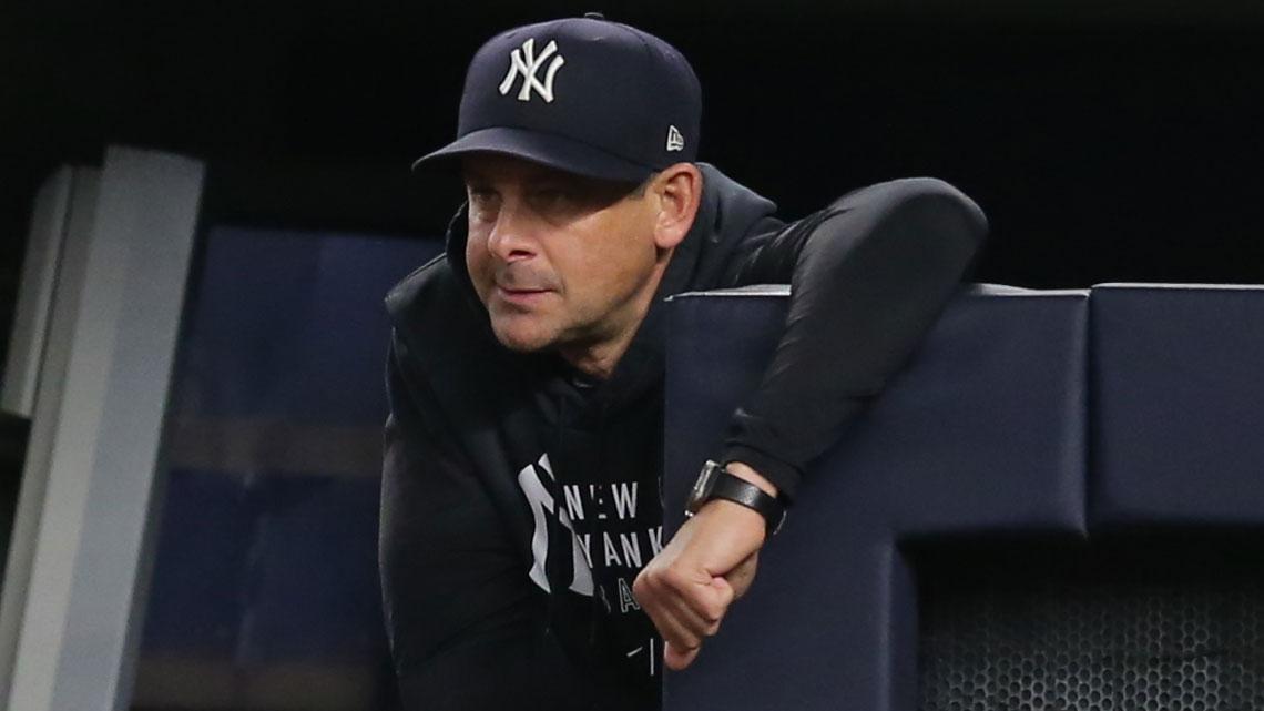 Jun 4, 2021; Bronx, New York, USA; New York Yankees manager Aaron Boone (19) looks on from the dugout during the ninth inning against the Boston Red Sox at Yankee Stadium. / Brad Penner-USA TODAY Sports