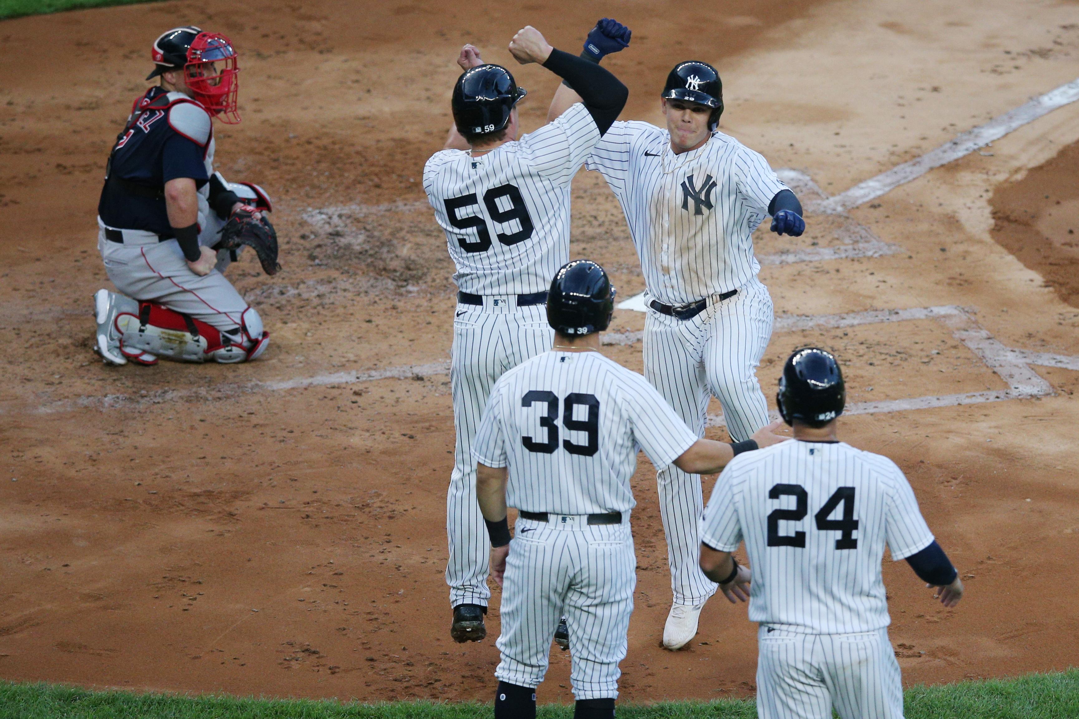 Aug 1, 2020; Bronx, New York, USA; New York Yankees third baseman Gio Urshela (29) celebrates his grand slam against the Boston Red Sox with first baseman Luke Voit (59) and left fielder Mike Tauchman (39) and catcher Gary Sanchez (24) during the second inning at Yankee Stadium. Mandatory Credit: Brad Penner-USA TODAY Sports / Brad Penner-USA TODAY Sports
