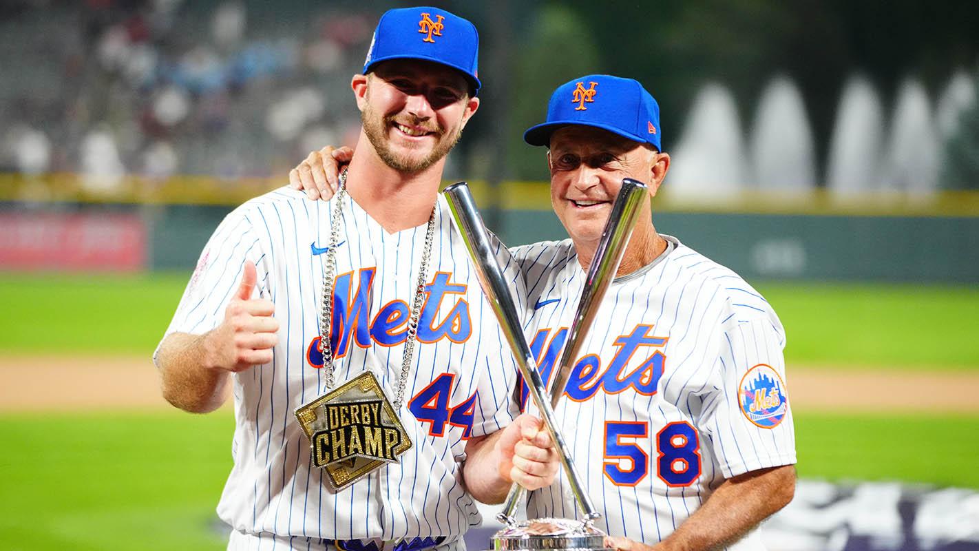 Jul 12, 2021; Denver, CO, USA; New York Mets first baseman Pete Alonso poses for photographs with bench coach Dave Jauss and the winners trophy following his victory in the 2021 MLB Home Run Derby. / Mark J. Rebilas-USA TODAY Sports