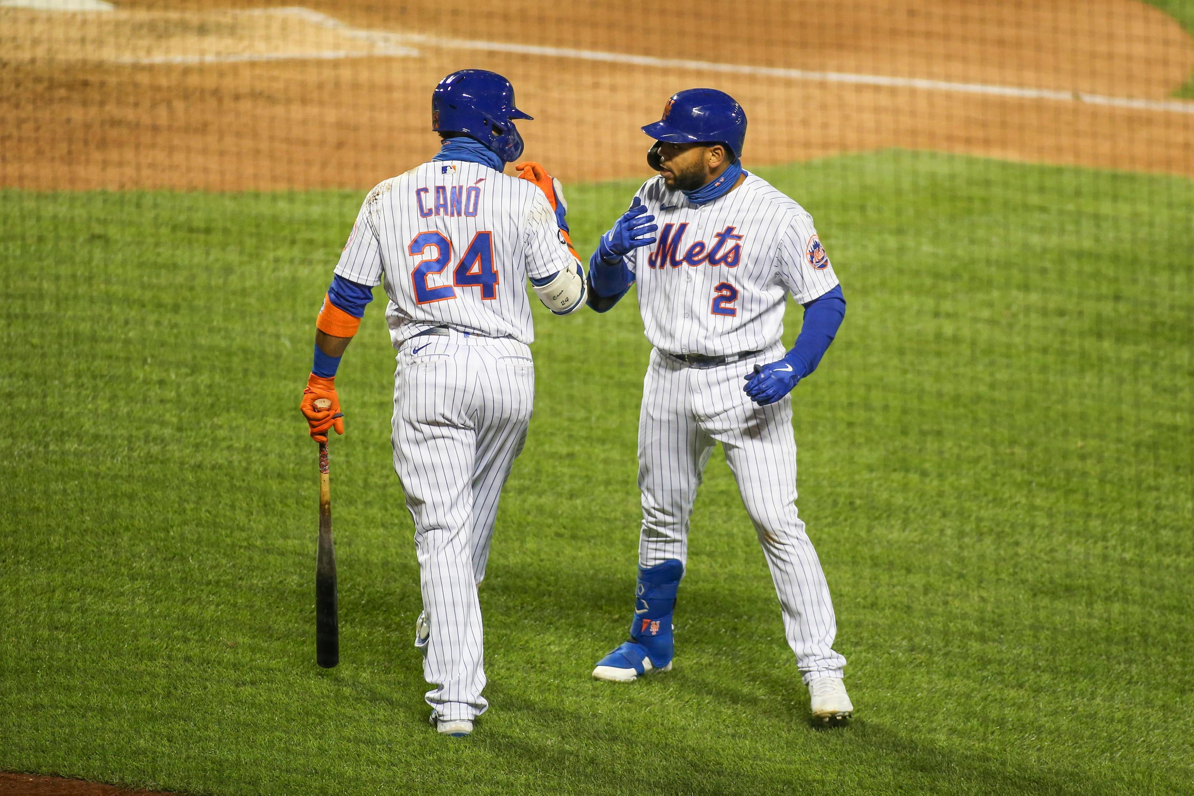 Sep 19, 2020; New York City, New York, USA;New York Mets first baseman Dominic Smith (2) celebrates with second baseman Robinson Cano (24) after hitting a home run in the eighth inning against the Atlanta Braves at Citi Field. / Wendell Cruz-USA TODAY Sports