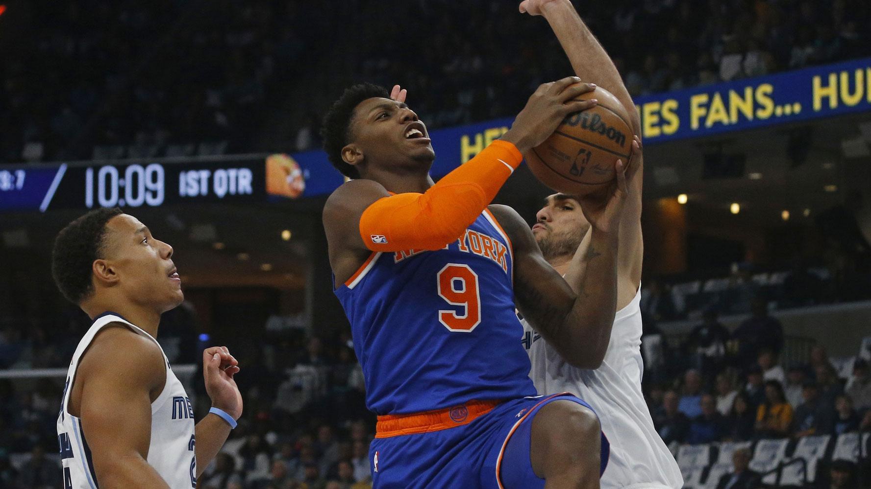 Oct 19, 2022; Memphis, Tennessee, USA; New York Knicks guard RJ Barrett (9) drives to the basket between Memphis Grizzlies guard Desmond Bane (left) and forward Santi Aldama (right) during the first quarter at FedExForum. / Petre Thomas-USA TODAY Sports